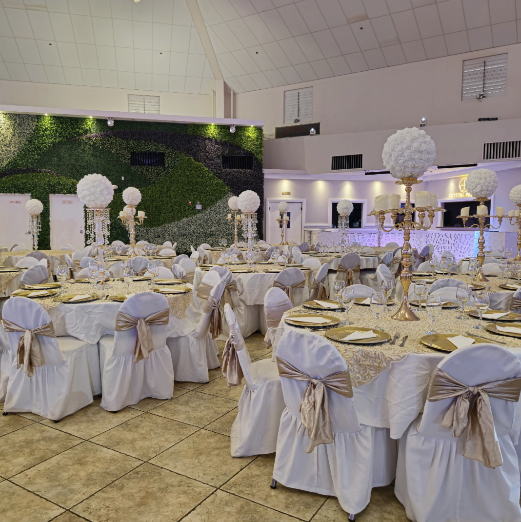 Crystal Palace Ballroom decorated with white linens, gold accents, and elegant centerpieces for a special event