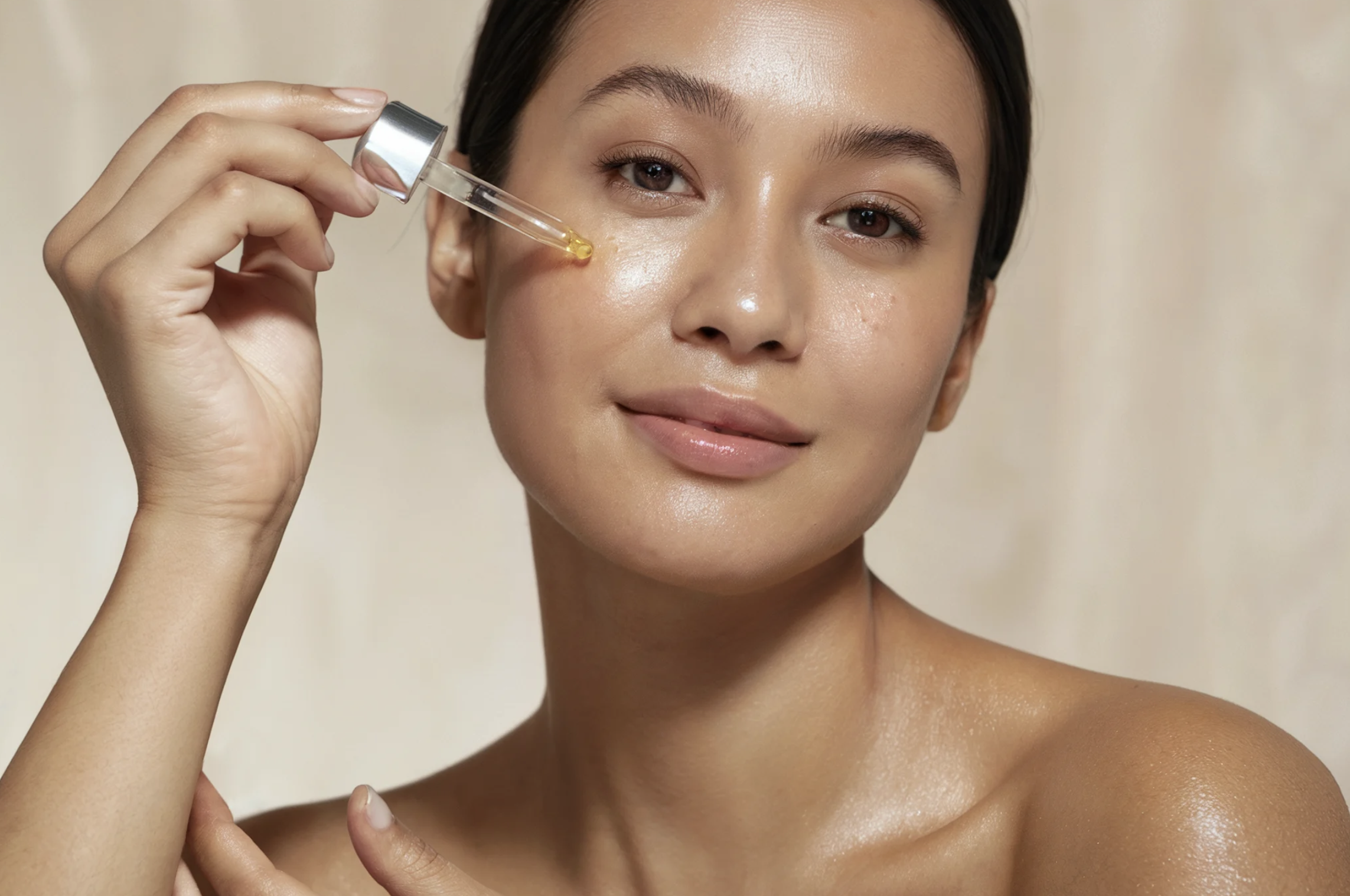 Woman applying skincare serum to her face for beauty and skincare treatments