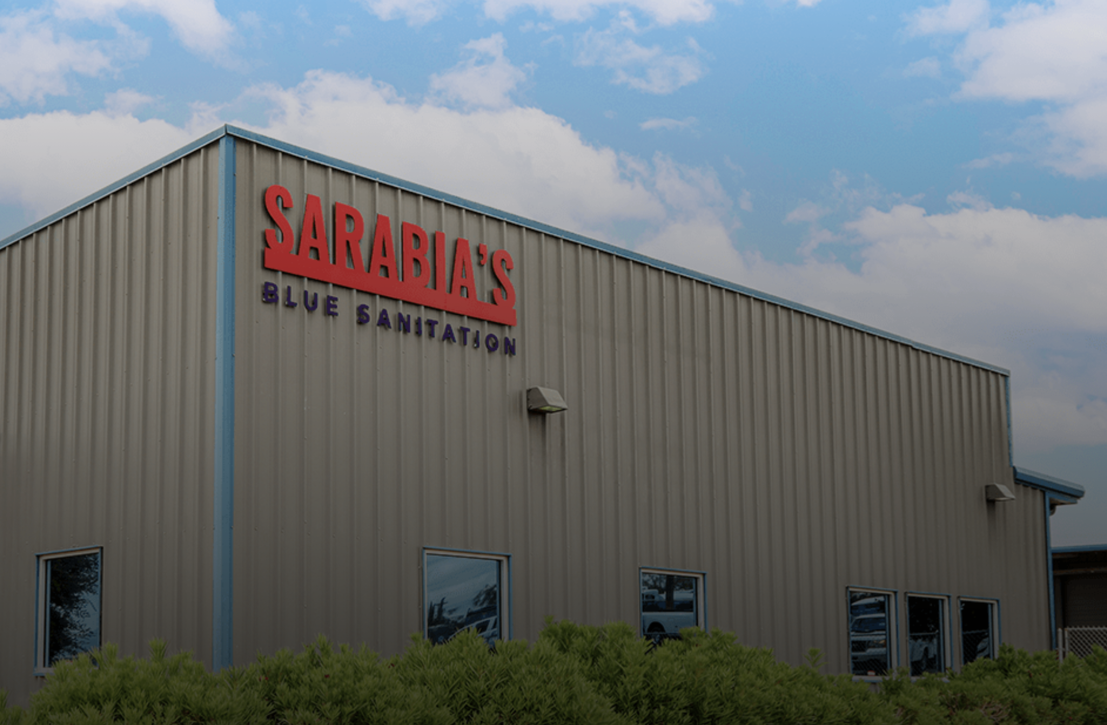 Exterior of Sarabia’s Blue Sanitation building with the company name displayed on the front.