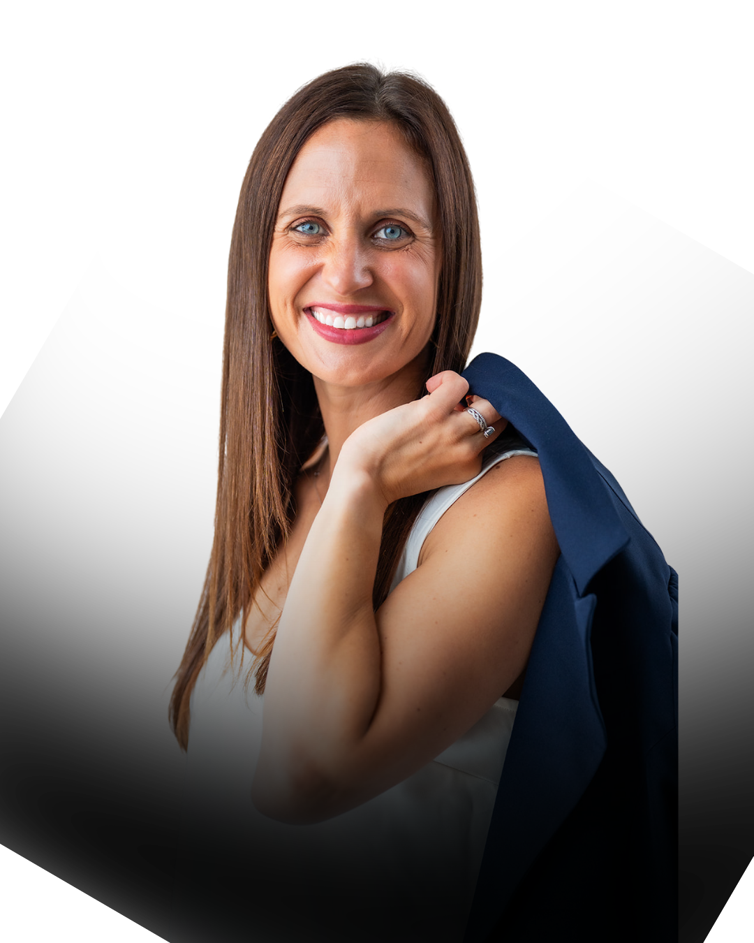 Lisa Tarkington - A smiling woman with long brown hair, holding a navy blue blazer over her shoulder, wearing a white sleeveless top, and smiling at the camera.