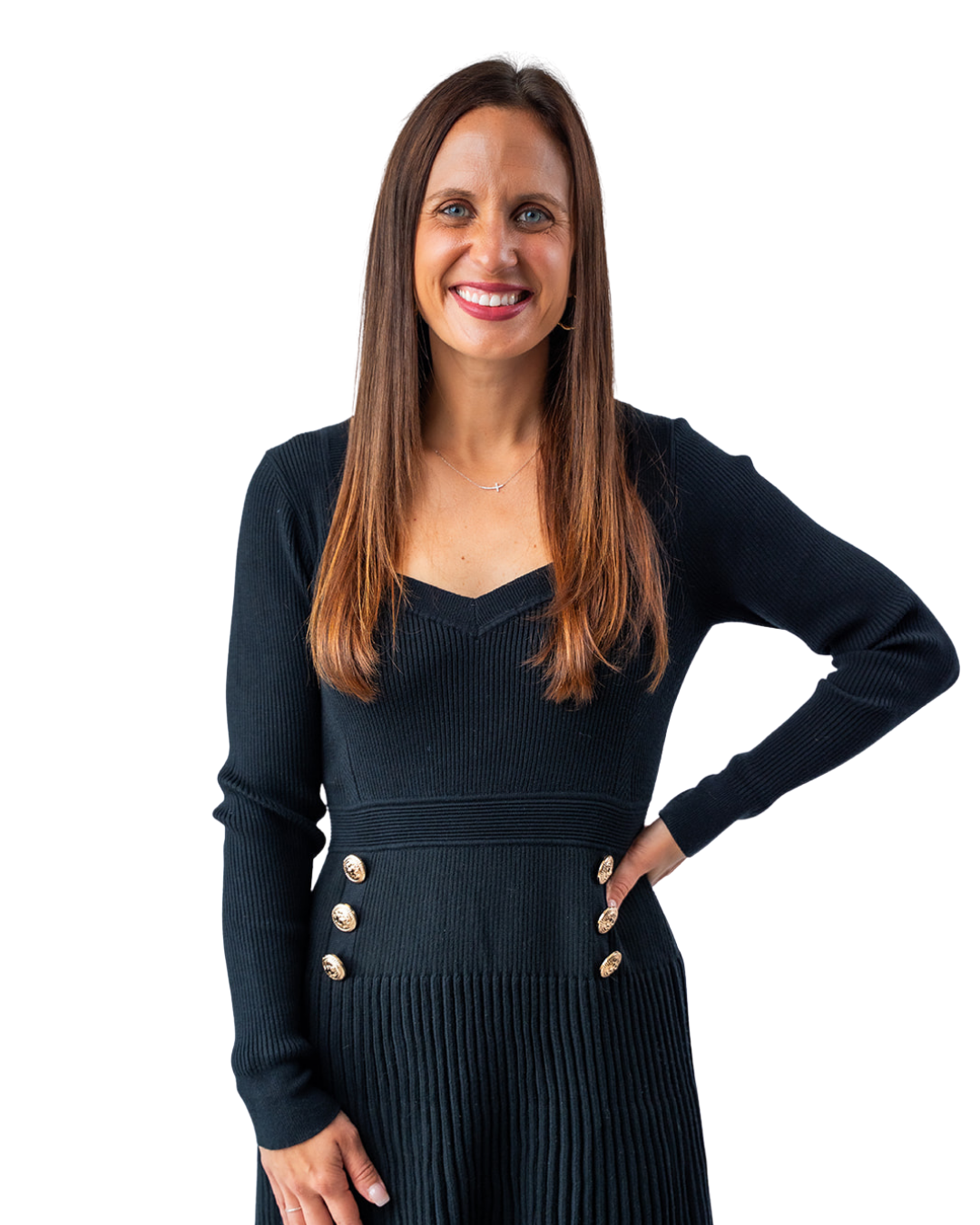 Portrait of a woman with long brown hair, wearing a black ribbed long-sleeve dress with gold buttons, smiling with one hand on her hip.