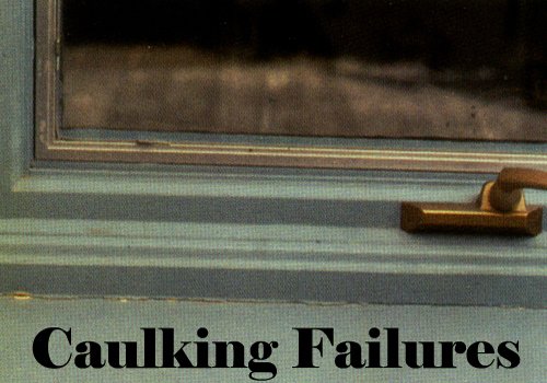 Close-up of a sign with the words 'Caulking Failures' written on it, near a window.