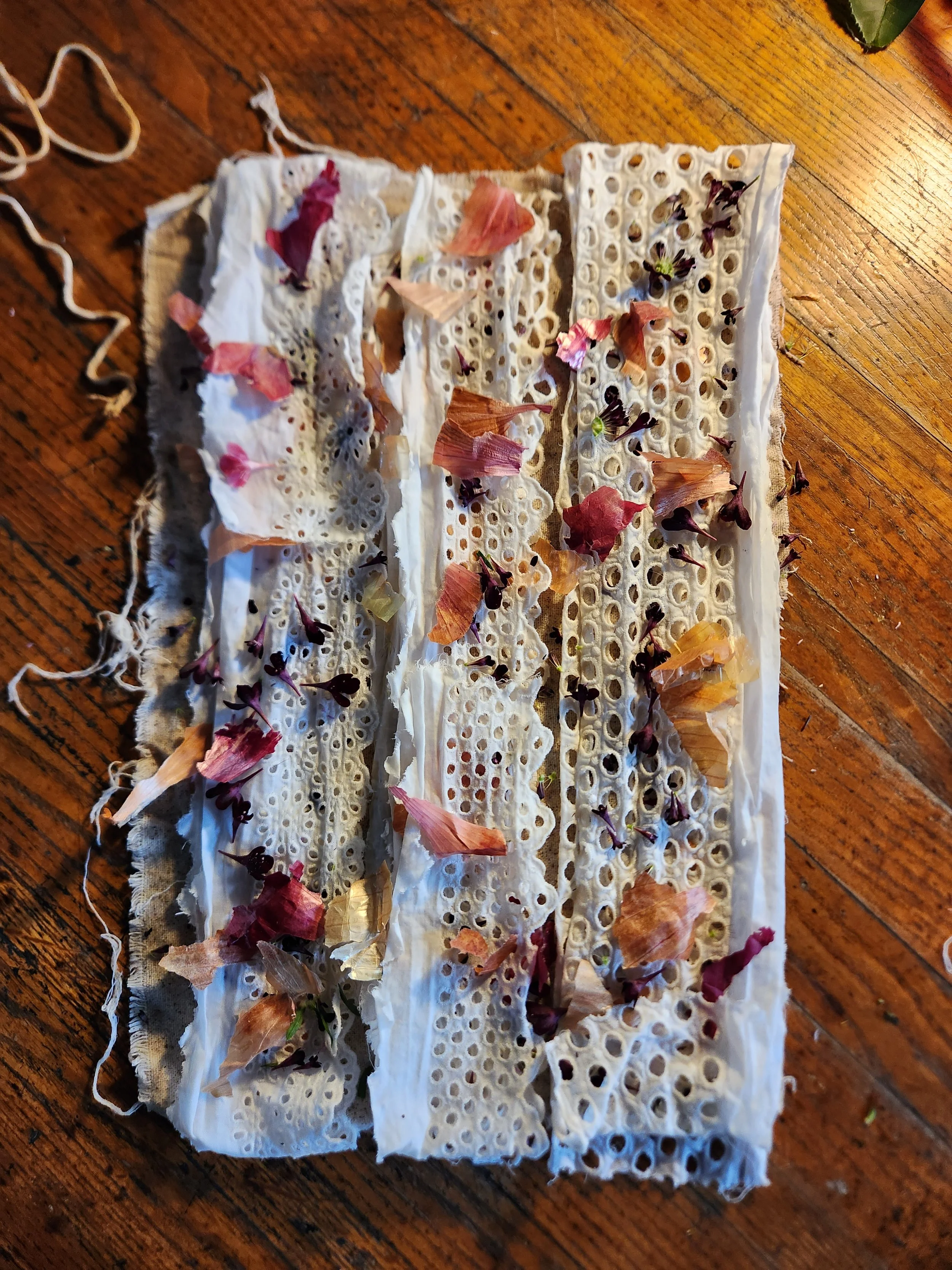 Eco-bundle dyeing exploration with natural leaf prints and earthy botanical textures on raw fabric
