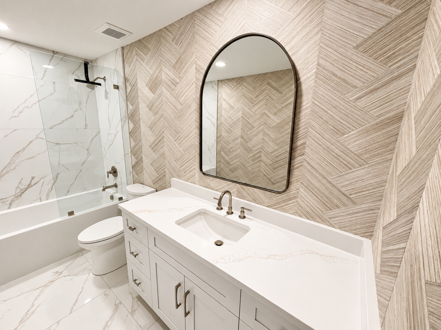 Modern bathroom with a marble floor, a bathtub with a glass shower screen, a white vanity with a marble countertop, an oval mirror, and wood-textured accent walls.