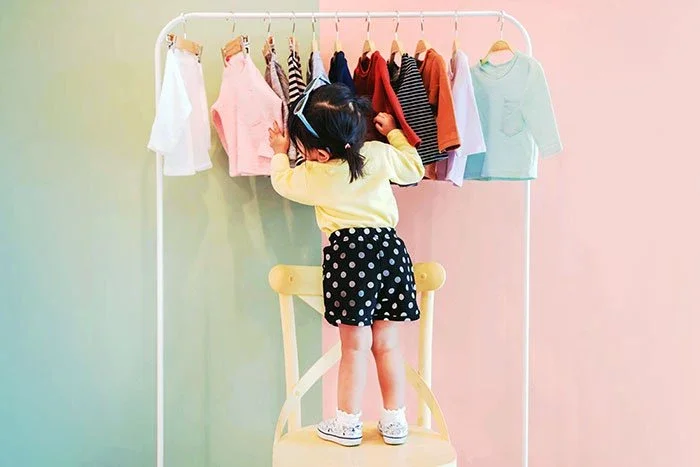Child looking through clothes