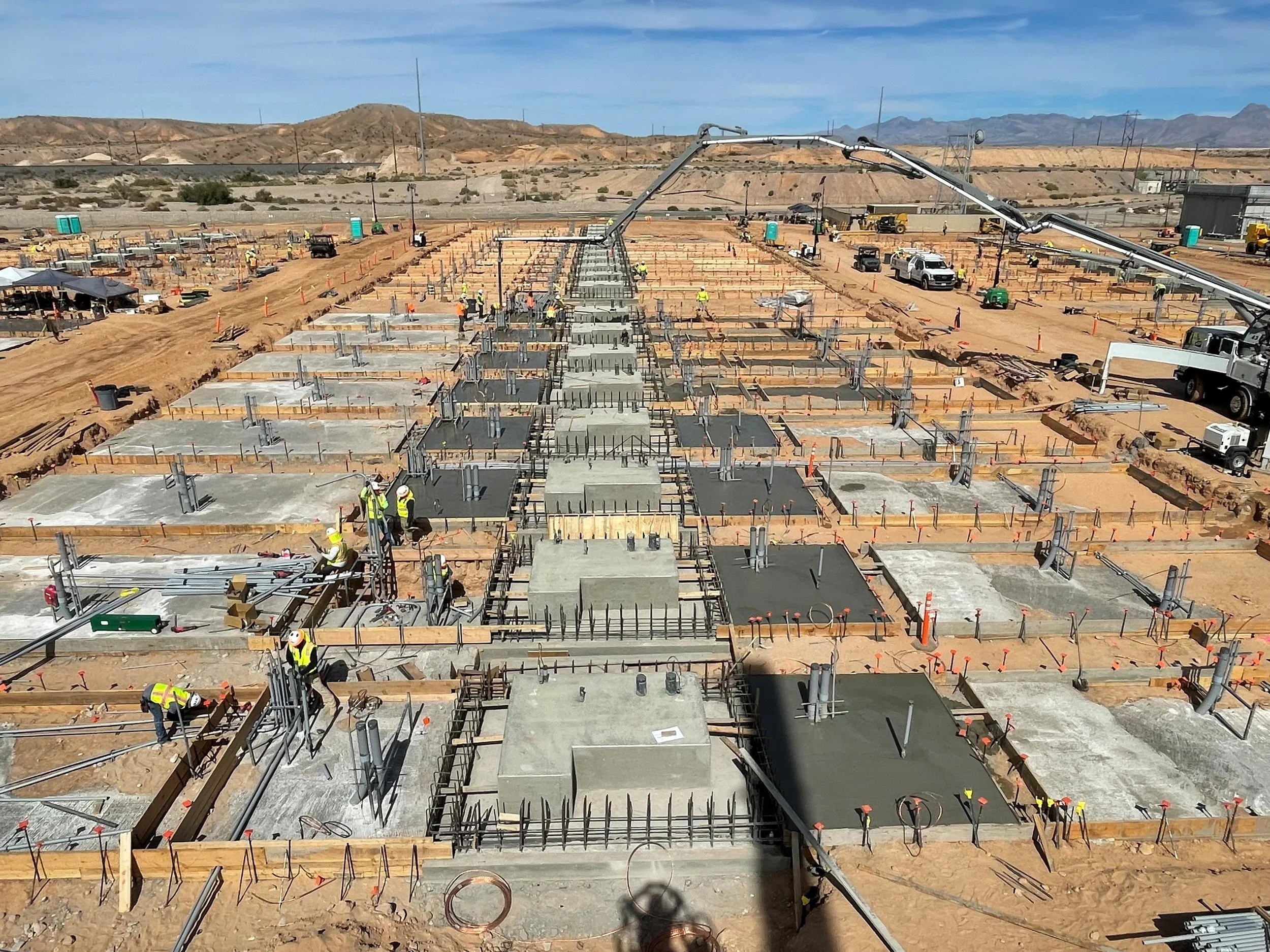 Crews placing foundations for a renewable energy project.