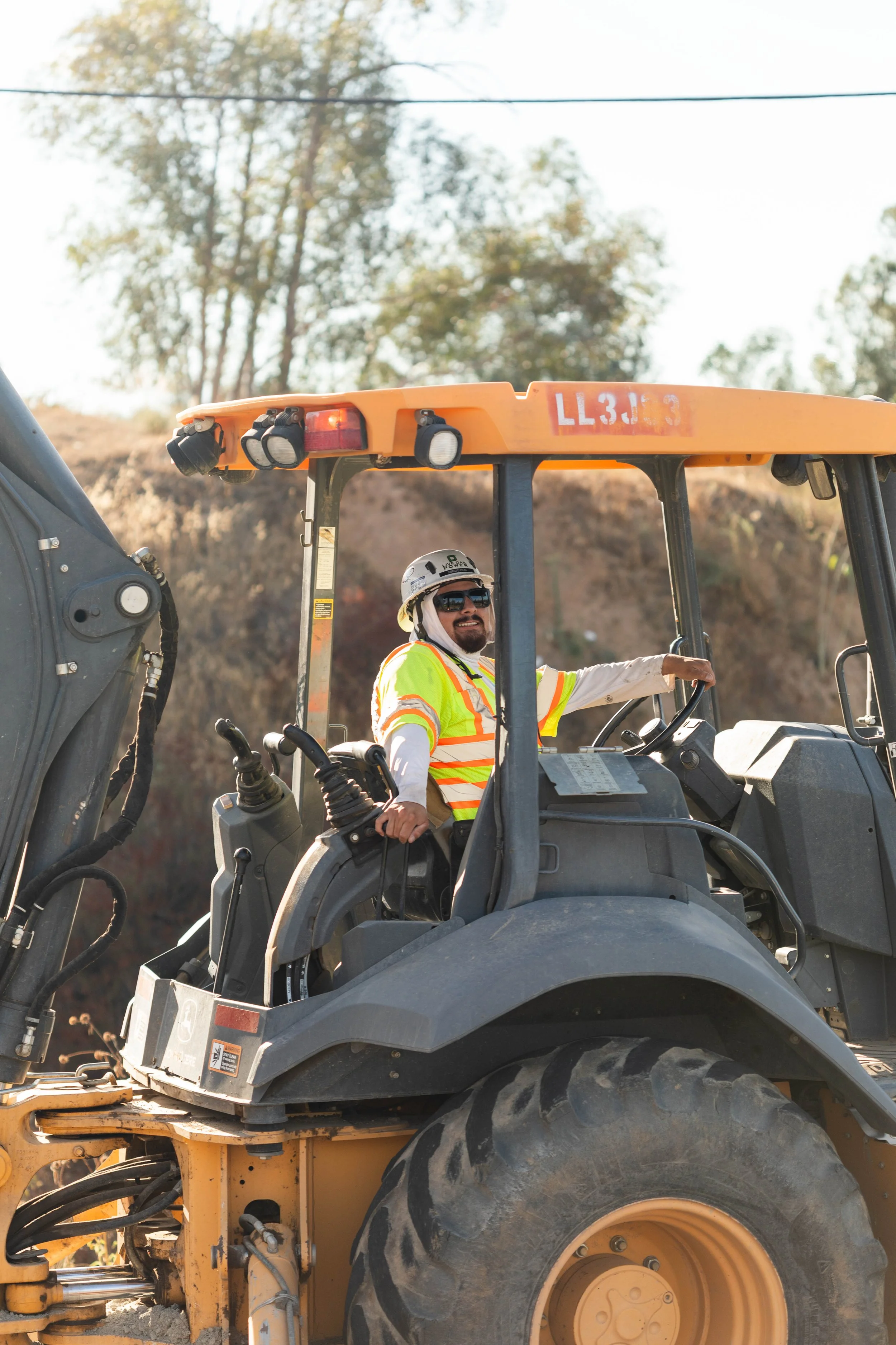 Operator running heavy equipment on a jobsite.