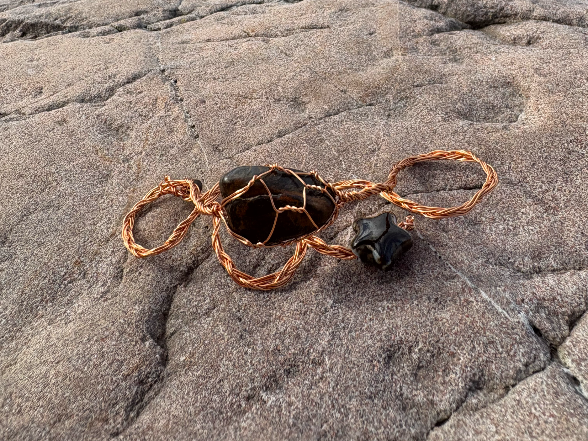 Athena. 

Hand-twisted copper wire. Blue tiger's eye and ceramic star.

£44