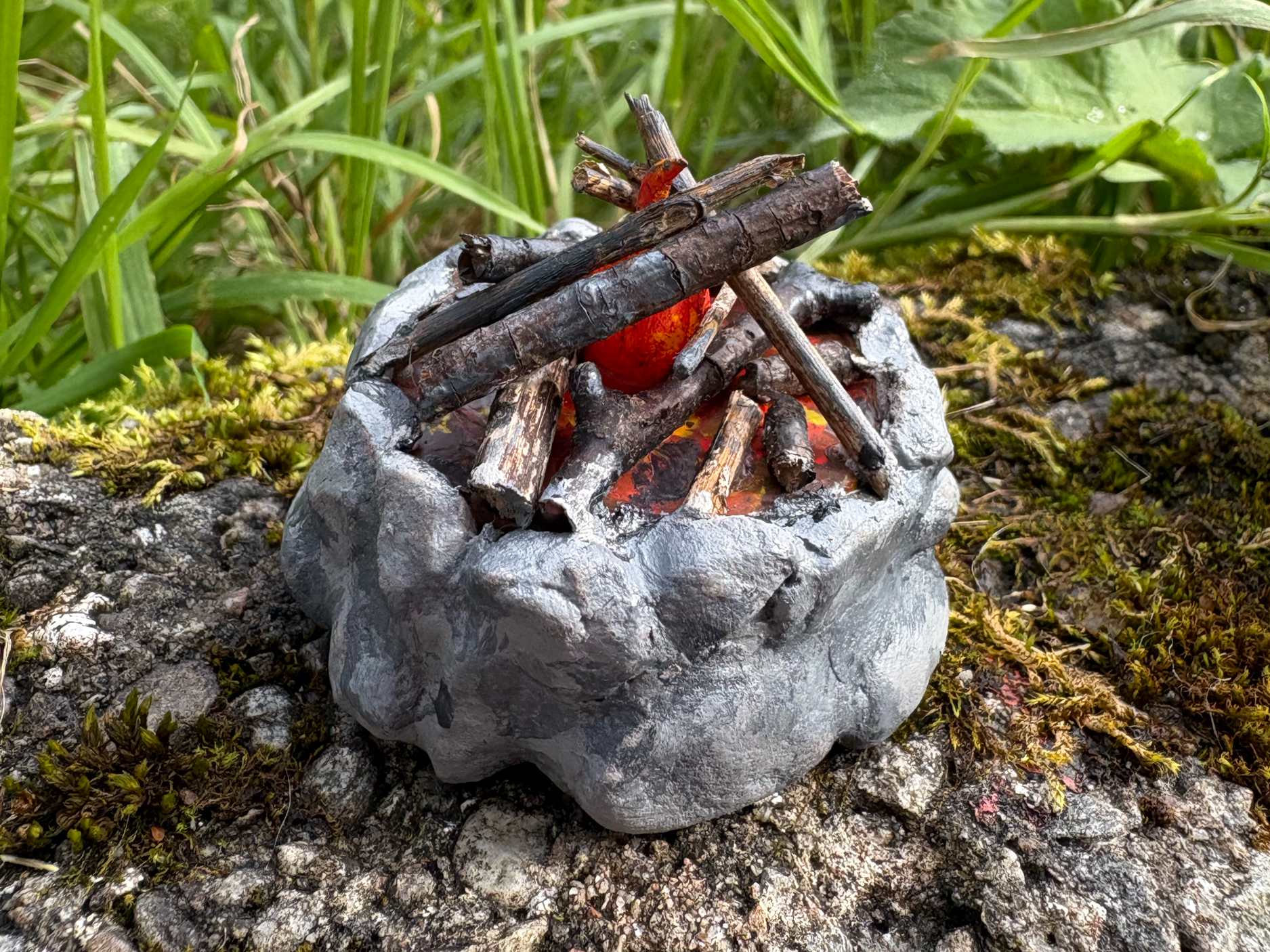 Camp 1. Battery tea light, stones, sticks, acrylic paint, air dry clay. 2026.