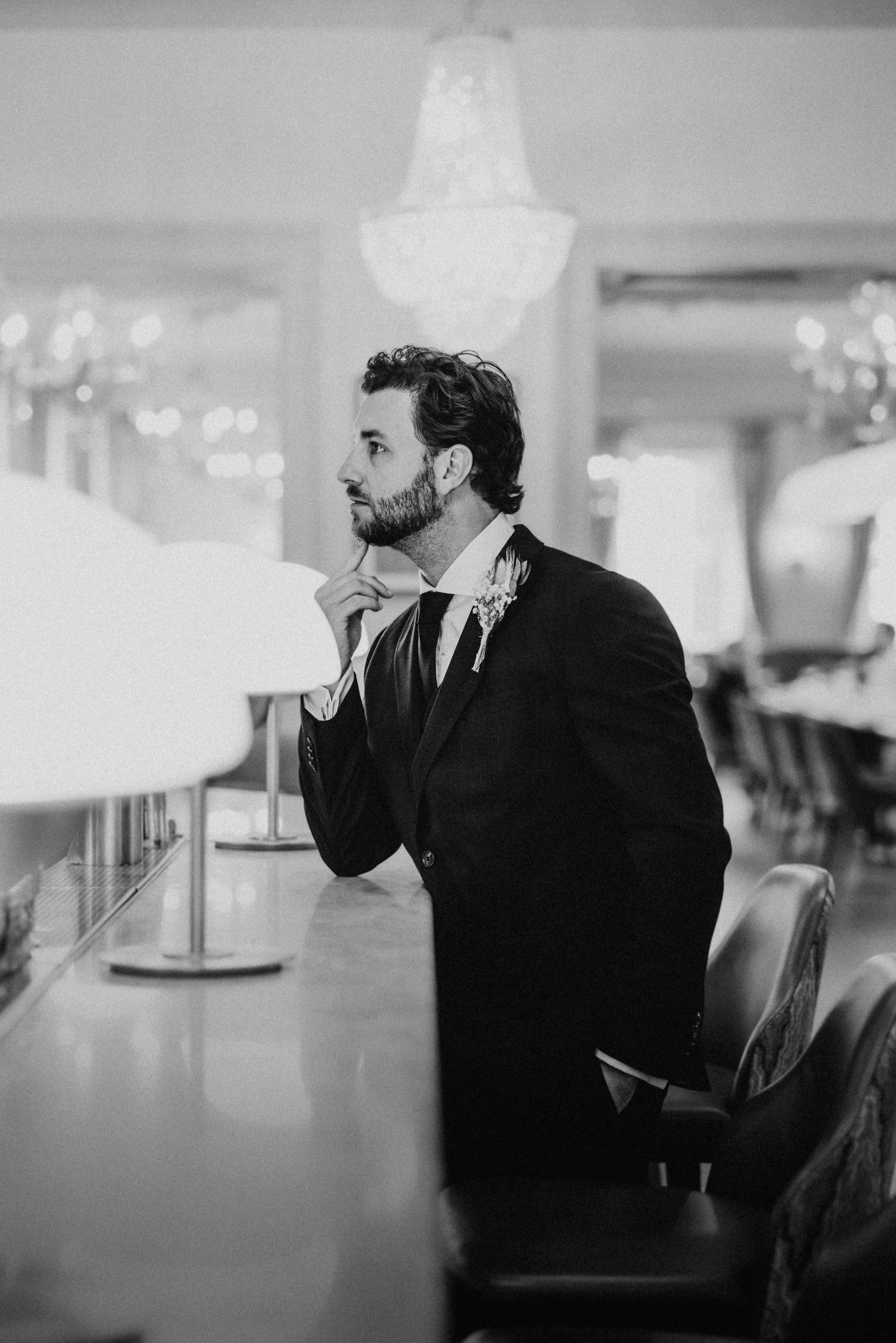 Documentary black and white groom portrait at bar venue - Josh Ward Creative