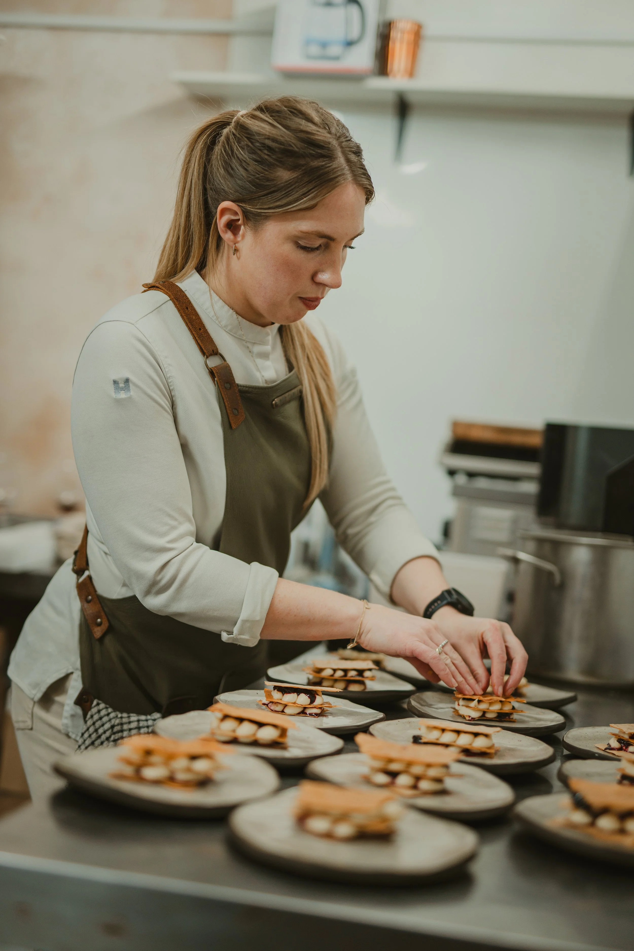 Pastry chef assembling plated courses during service prep, food photography - Josh Ward Creative