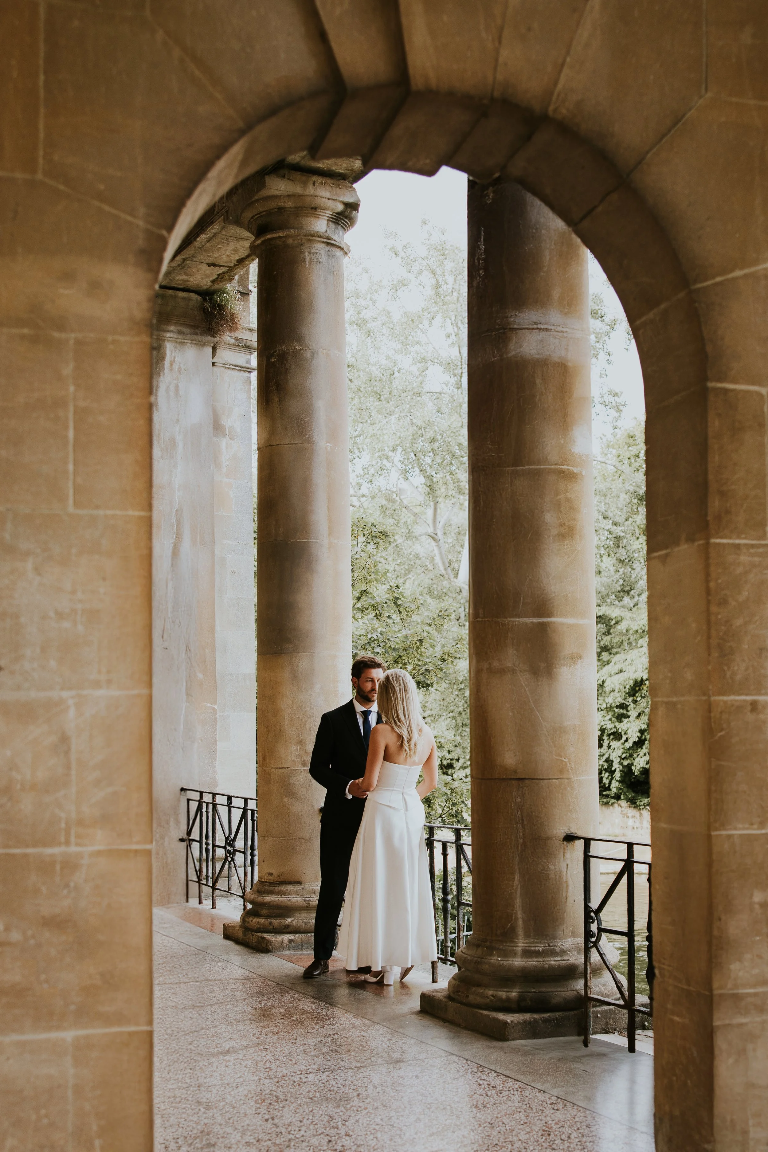 Documentary couple portrait framed by classical stone archway, Bath - Josh Ward Creative