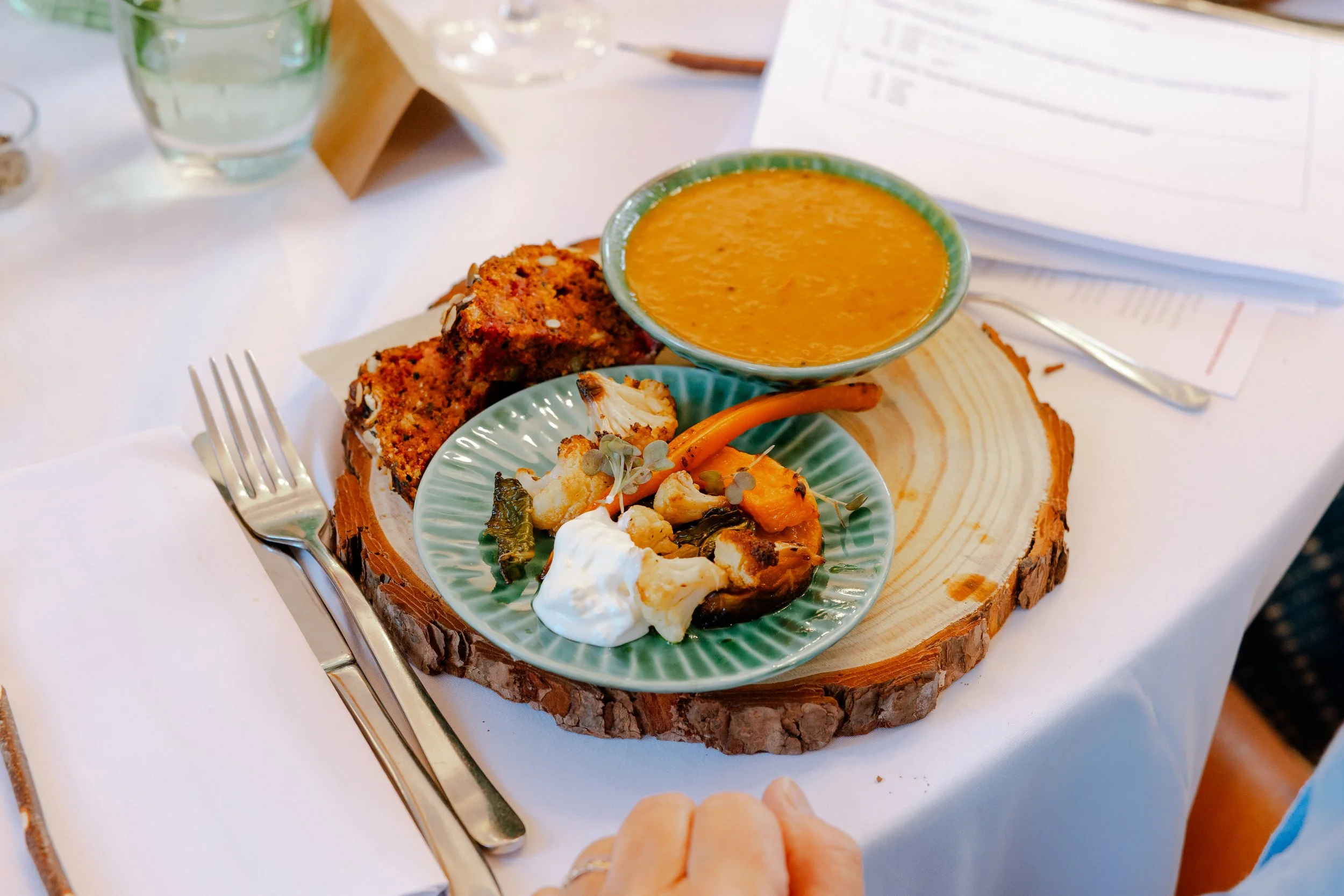 Rustic event dining soup and roasted side served on wood platter - Josh Ward Creative