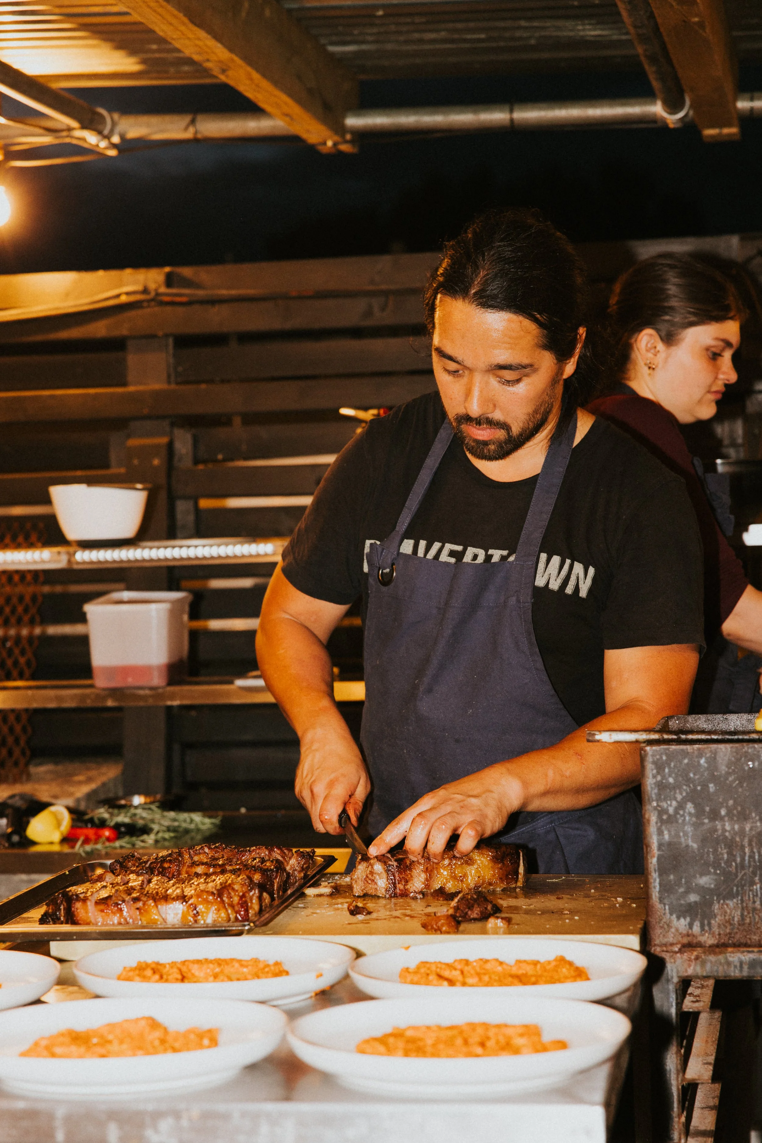 Outdoor kitchen service and chef carving meat for event dining, Somerset - Josh Ward Creative