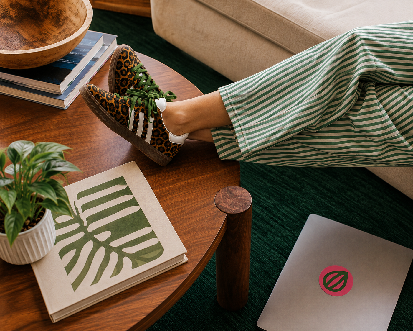 Person with their feet up beside a laptop in a relaxed workspace.
