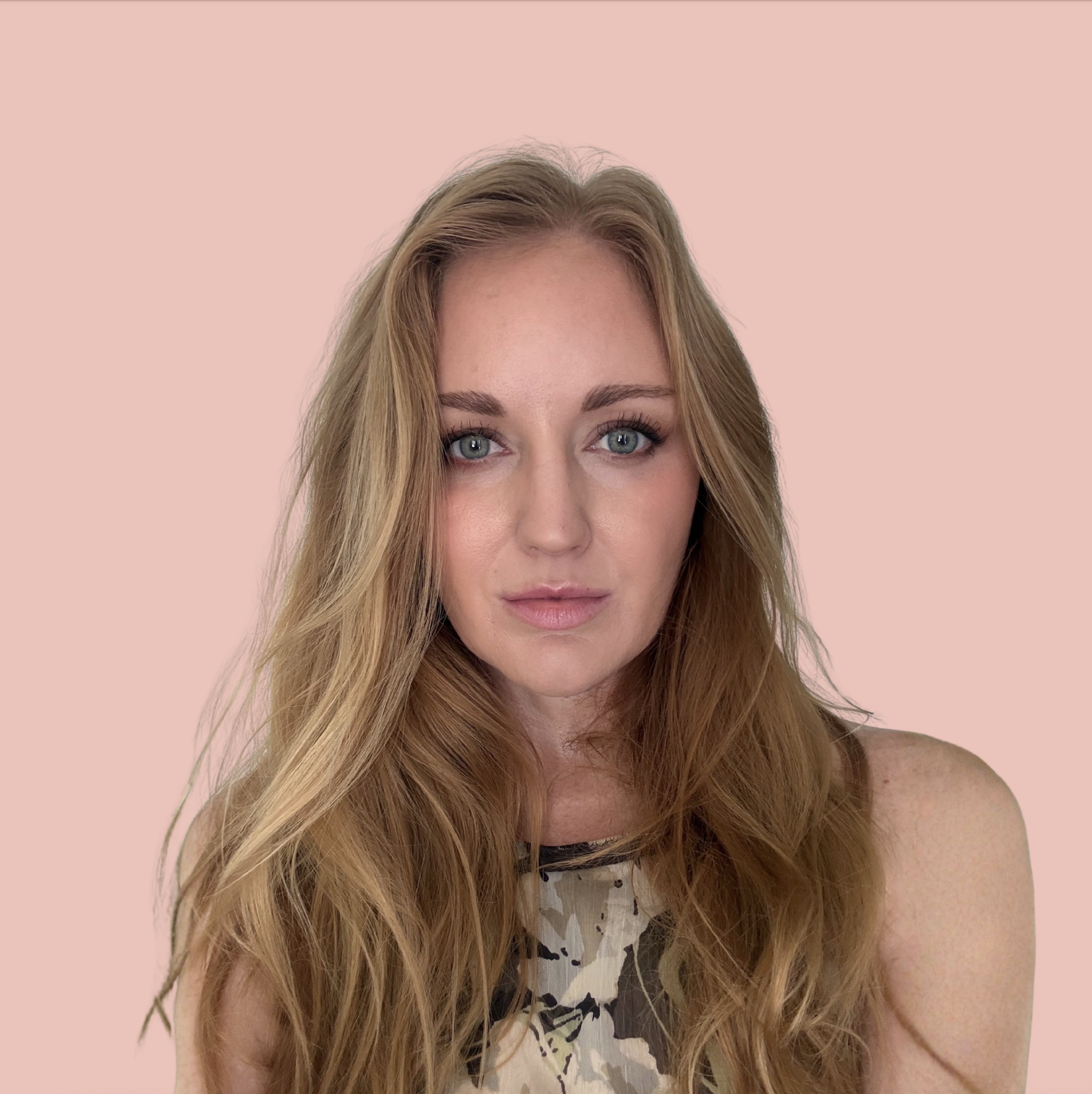 Reilly Curran on a pink background wearing a floral shirt