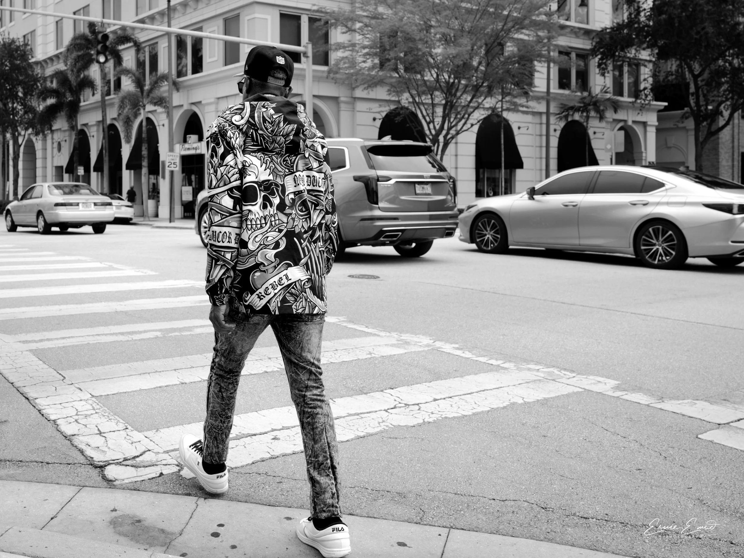 Walking across a busy Coral gables roadway in a Dias de los muertos rebel jacket