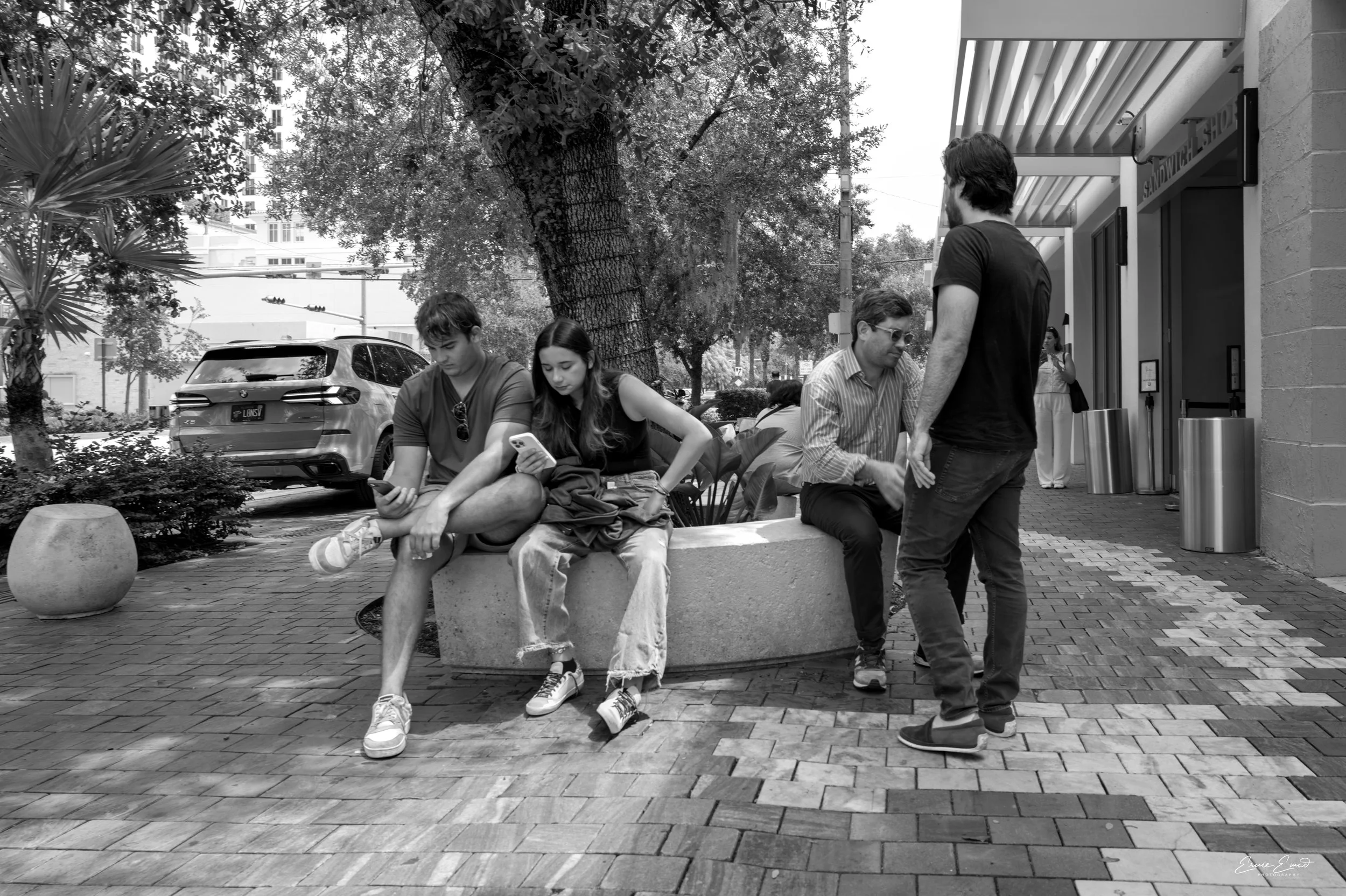 Miracle Mile Coral gables on a weekday with people sitting around  and standing near each other I wonder if they know each other 