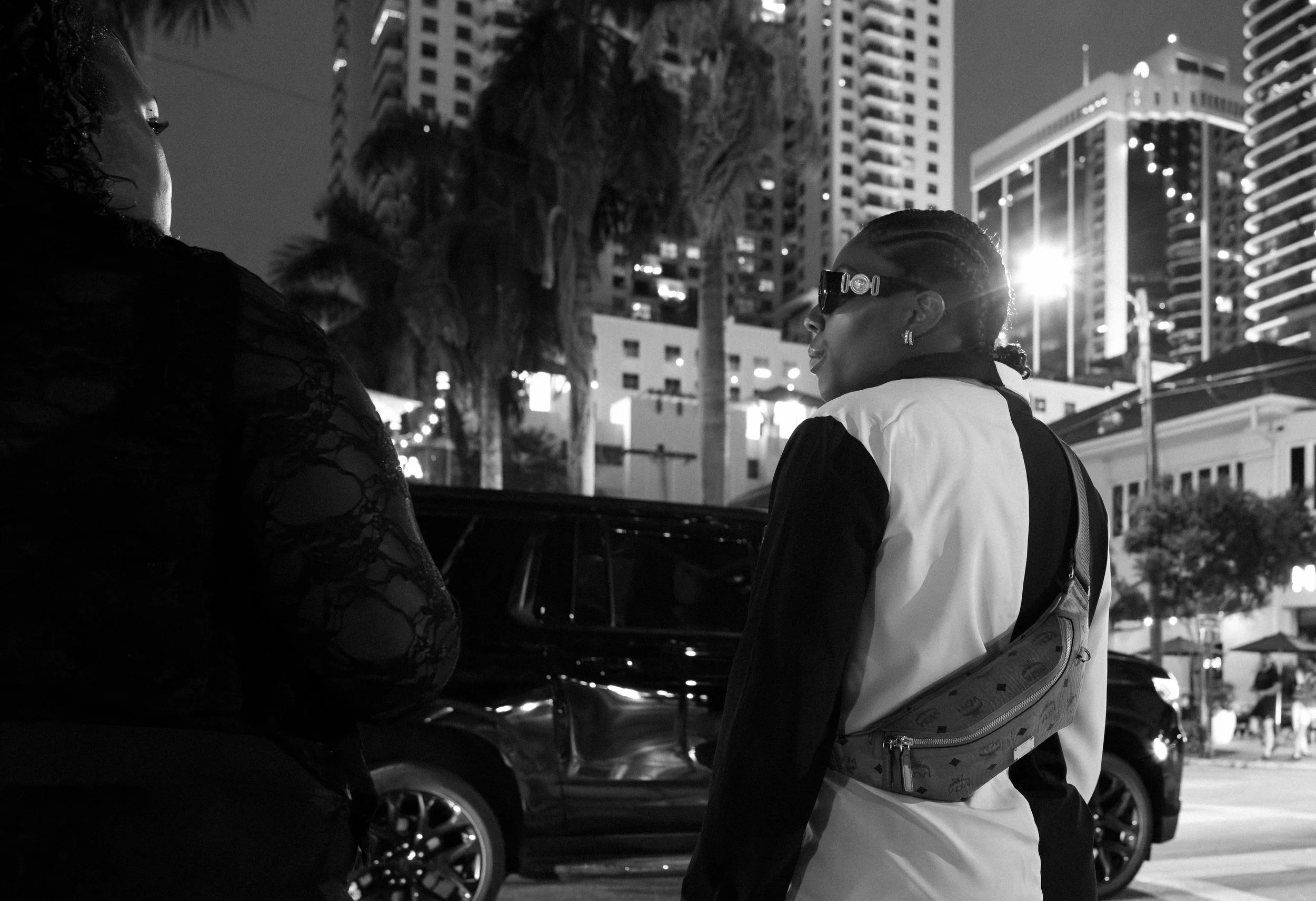 Cool cat waiting to cross the street from a Fish out of water in Brickell with designer sunglasses at night so I can see you better