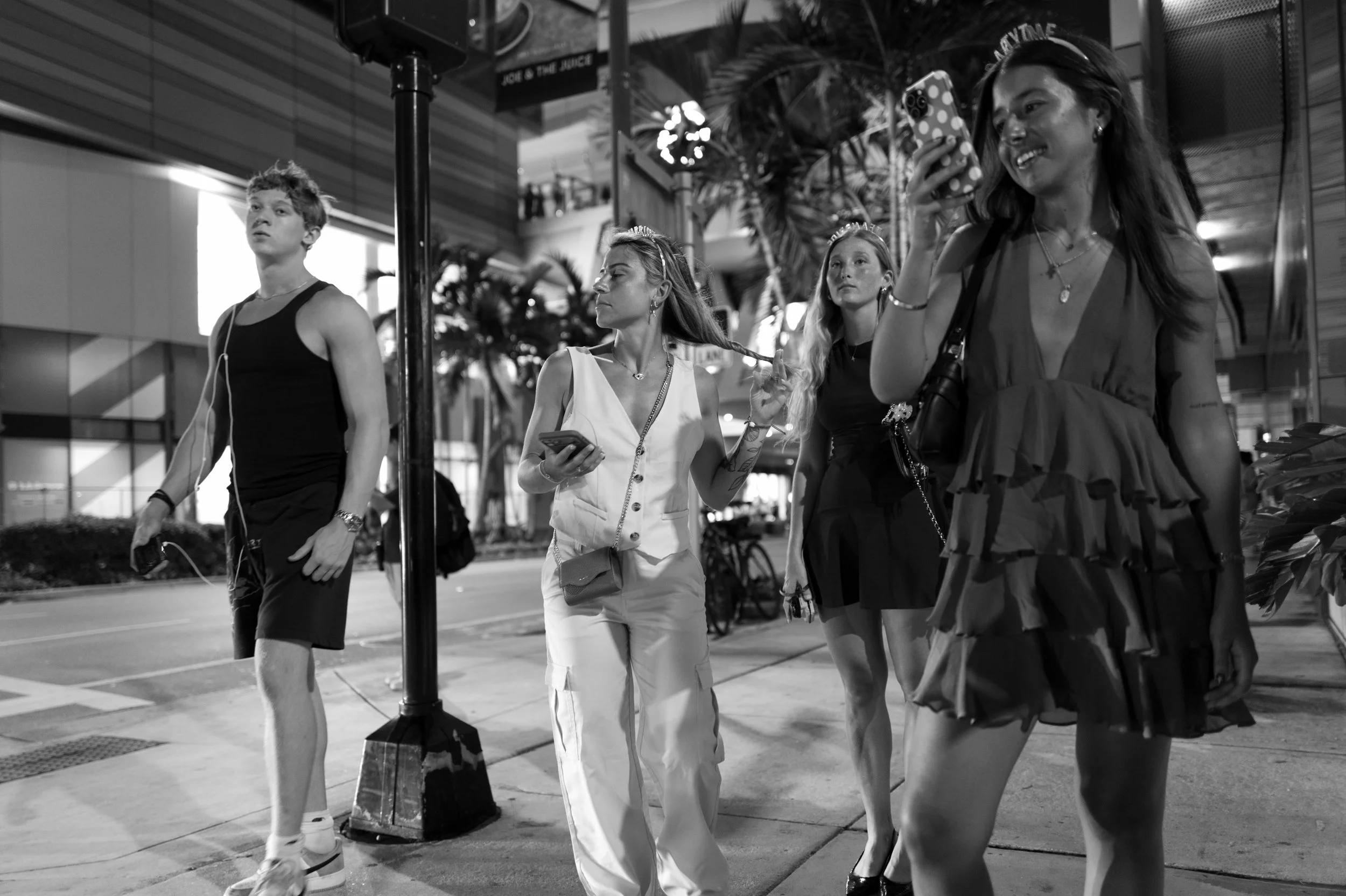 Young lady's celebrating something as they are all taking selfies with crowns on their heads in Brickell 