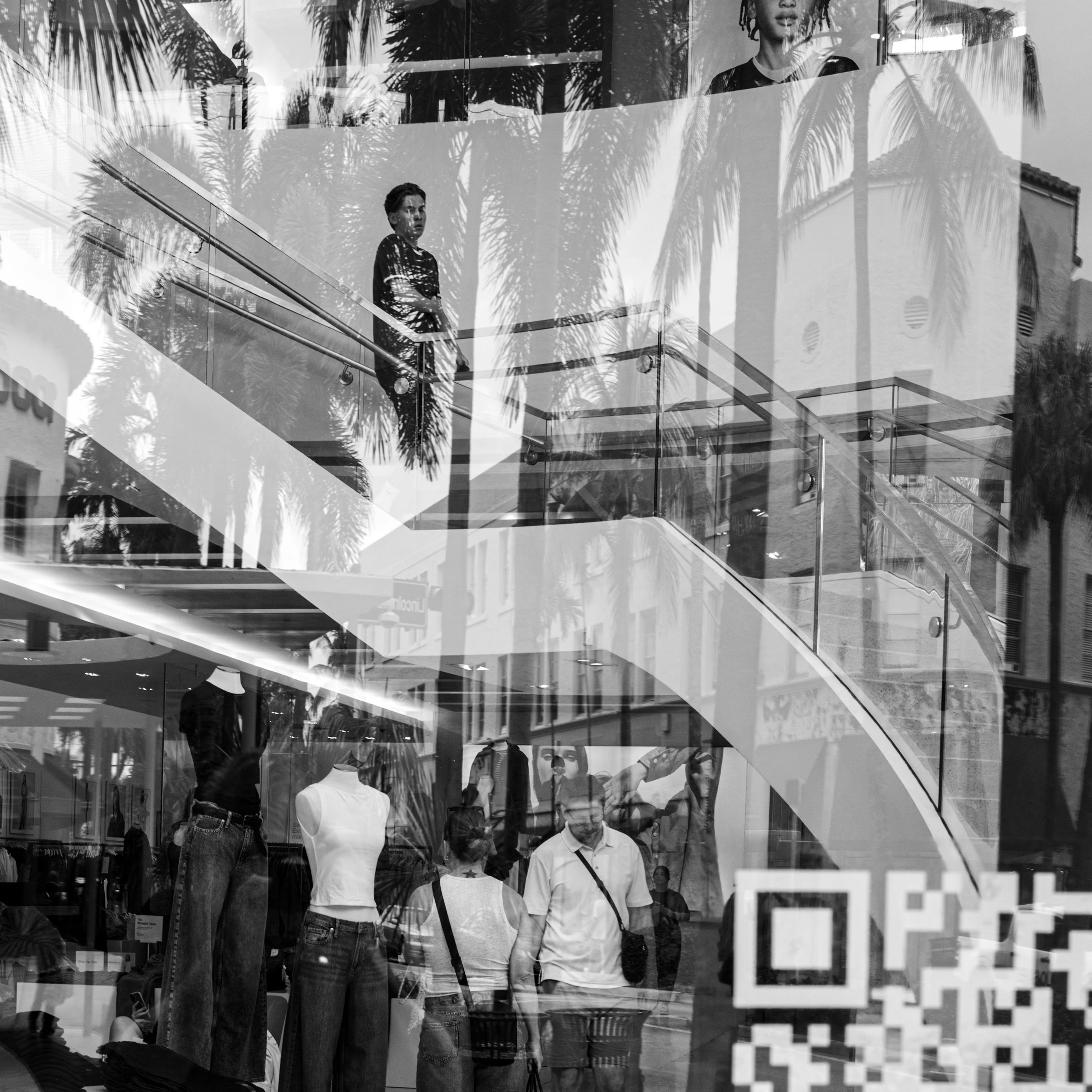 Reflections through a storefront on Lincoln Road with the not so famous walk down the escalator