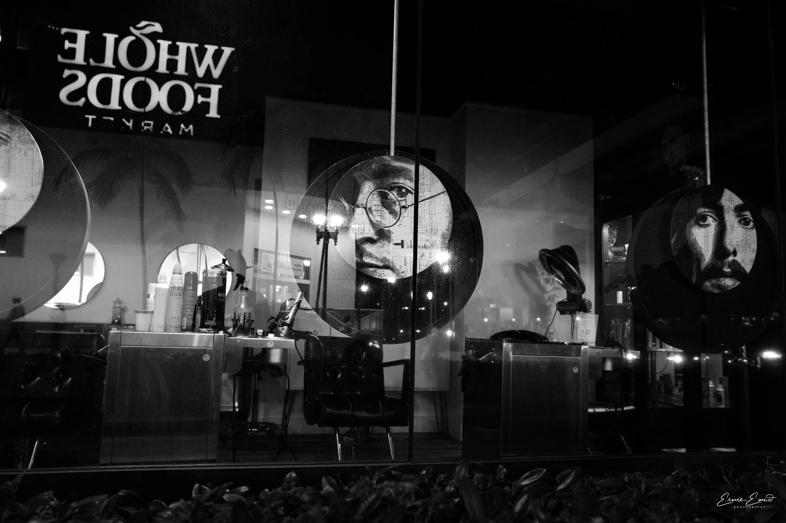 John Lennon and the Beatles in images that are printed on circles in a Beauty Salon with a reflection from the storefront Window Payne a Whole Foods sign from across the street in Downtown Miami