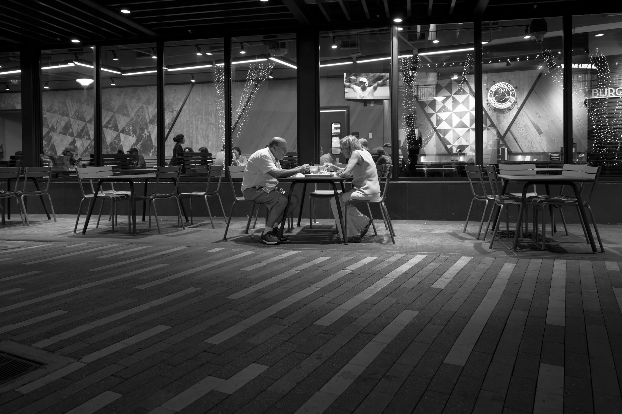 An older couple enjoying a quiet evening dinner alone in Brickell.  This type of solitude is very scarce in such as busy area of Miami