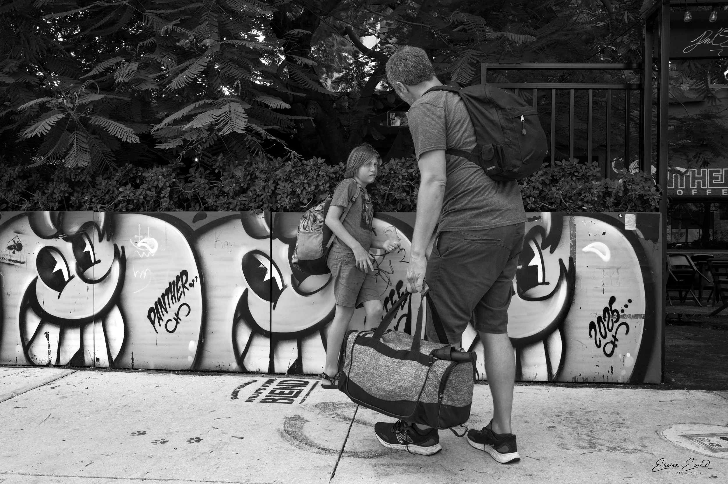 Dad taking an extreme closeup and son looks scared inferno of Panther Coffee Wynwood miami