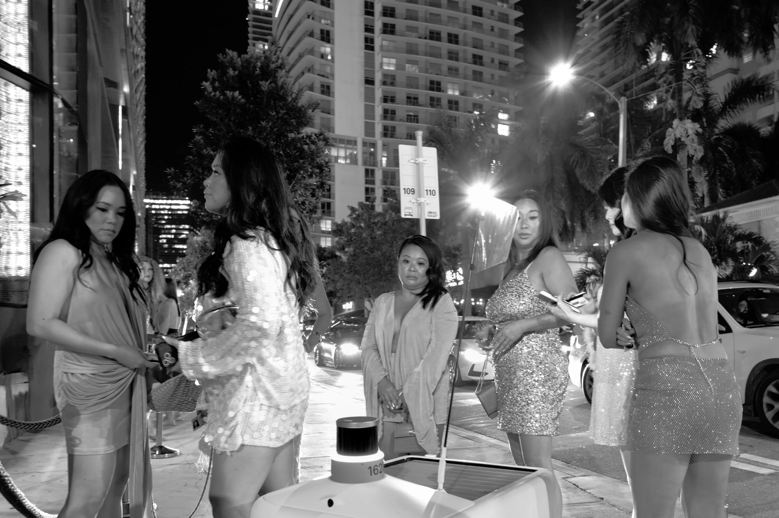 looks like a group of Asian sisters waiting to get in Fish out of Water with no room for the Amazon buggy to get back.  Traffic in Miami even on the sidewalks