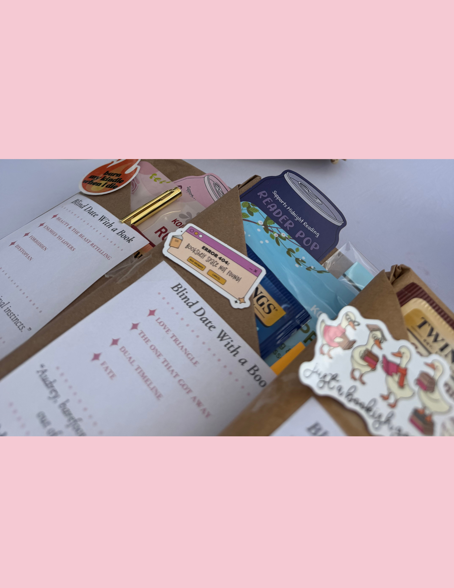 A collection of colorful stickers and paper items on a white surface, including book-related stickers and a note about a bookshop