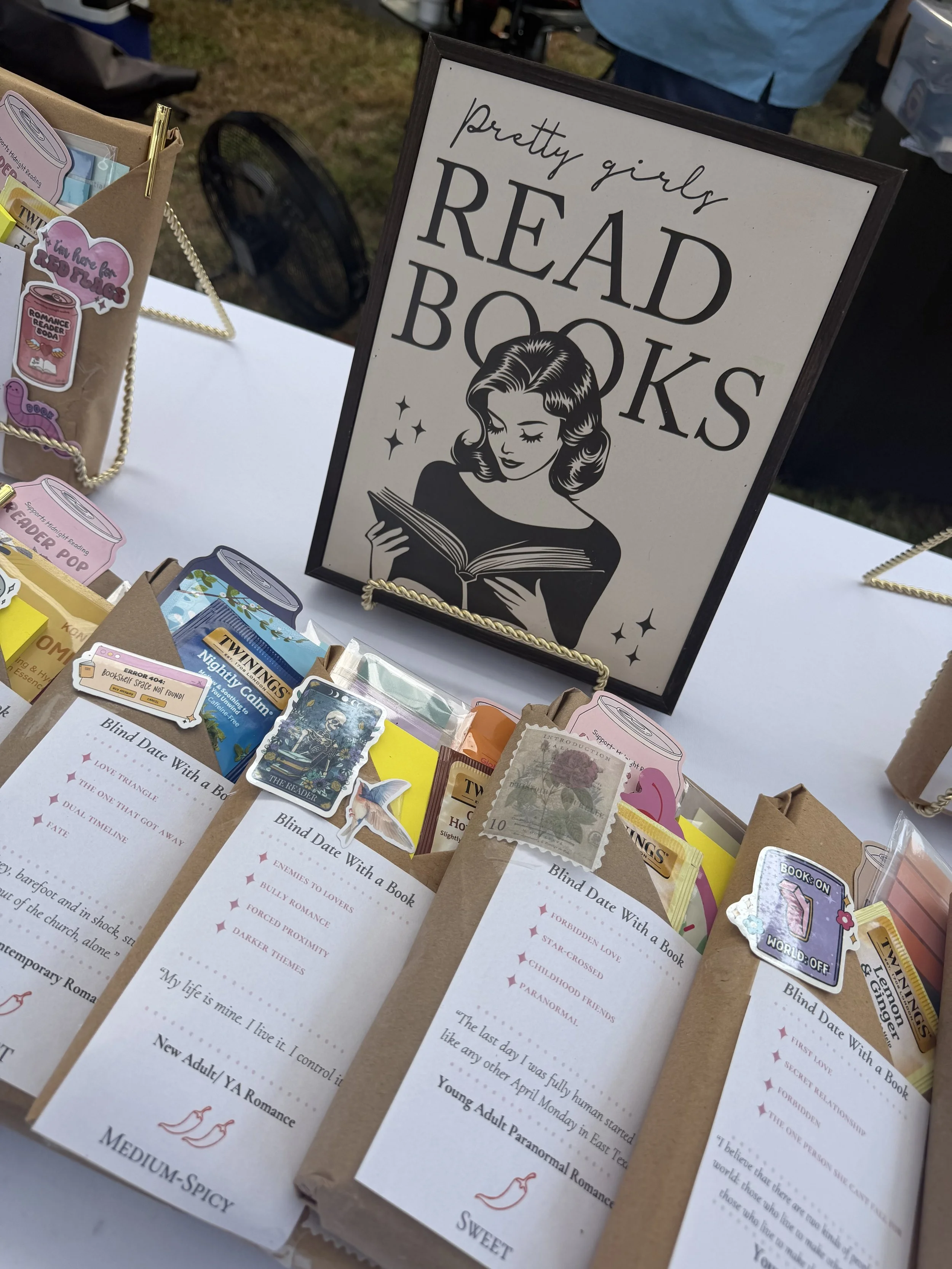 A sign reading 'pretty girls READ BOOKS' features a vintage illustration of a woman reading.