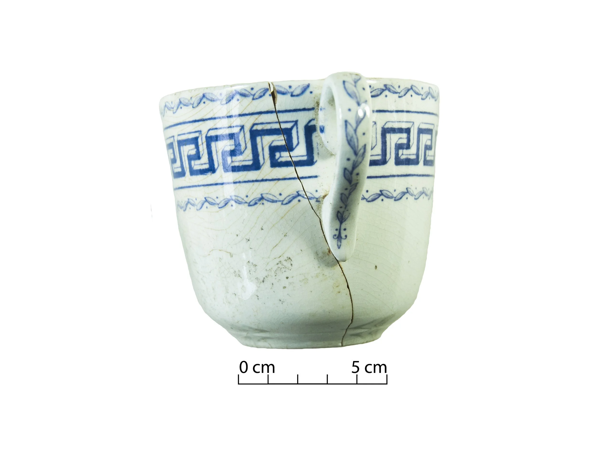 Earthenware tea cup, white with a Greek key pattern around the external rim, in blue.