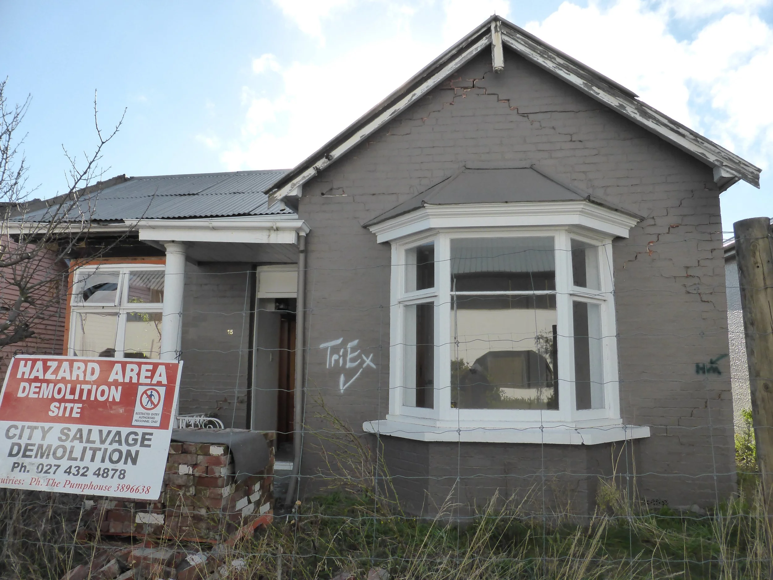 Single-storey brick bay cottage. The windows, door and porch are not original. Collapsed partly in the earthquakes.