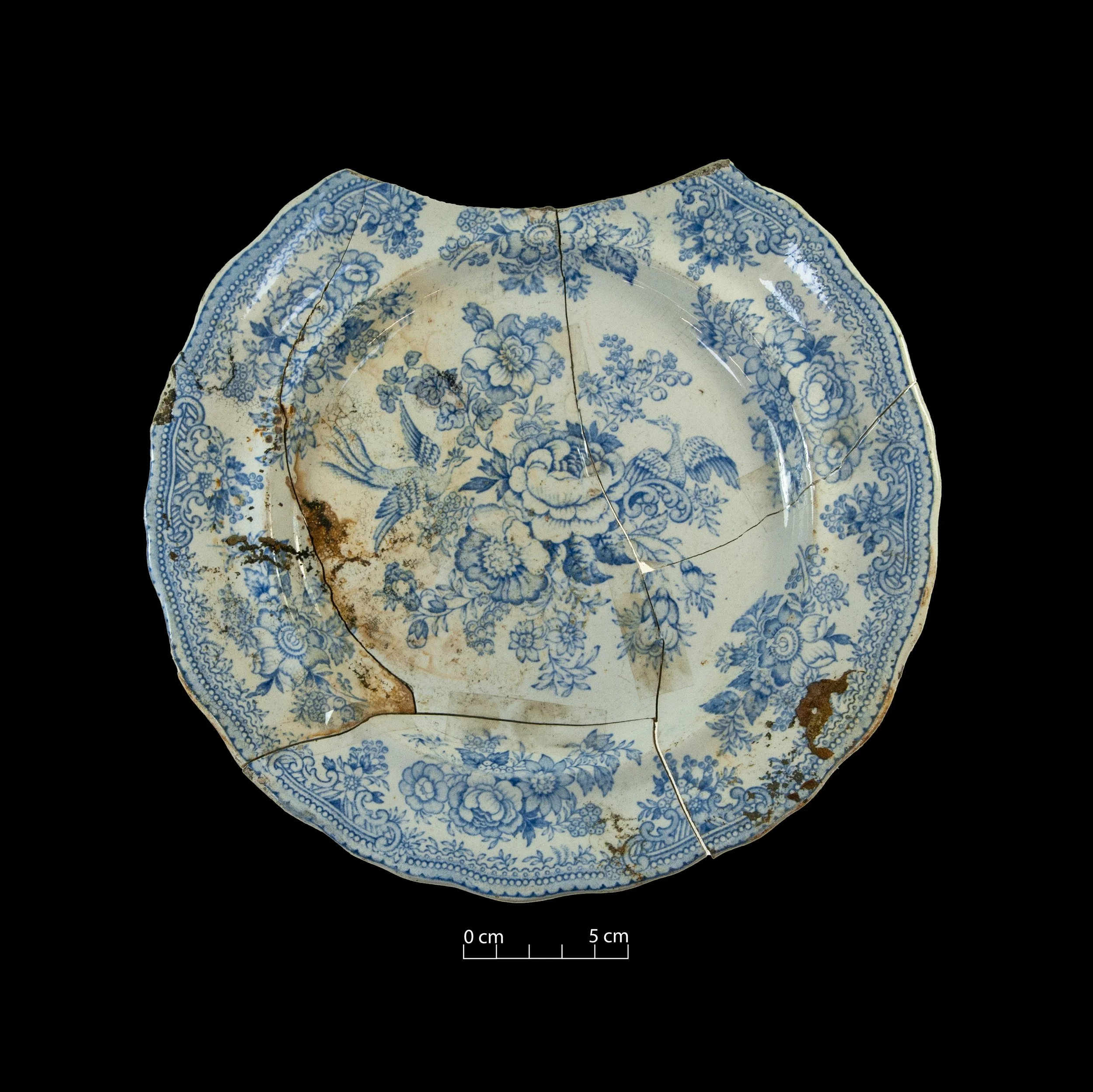White earthenware plate, decorated with the Asiatic Pheasants pattern (blue). Broken, incomplete.