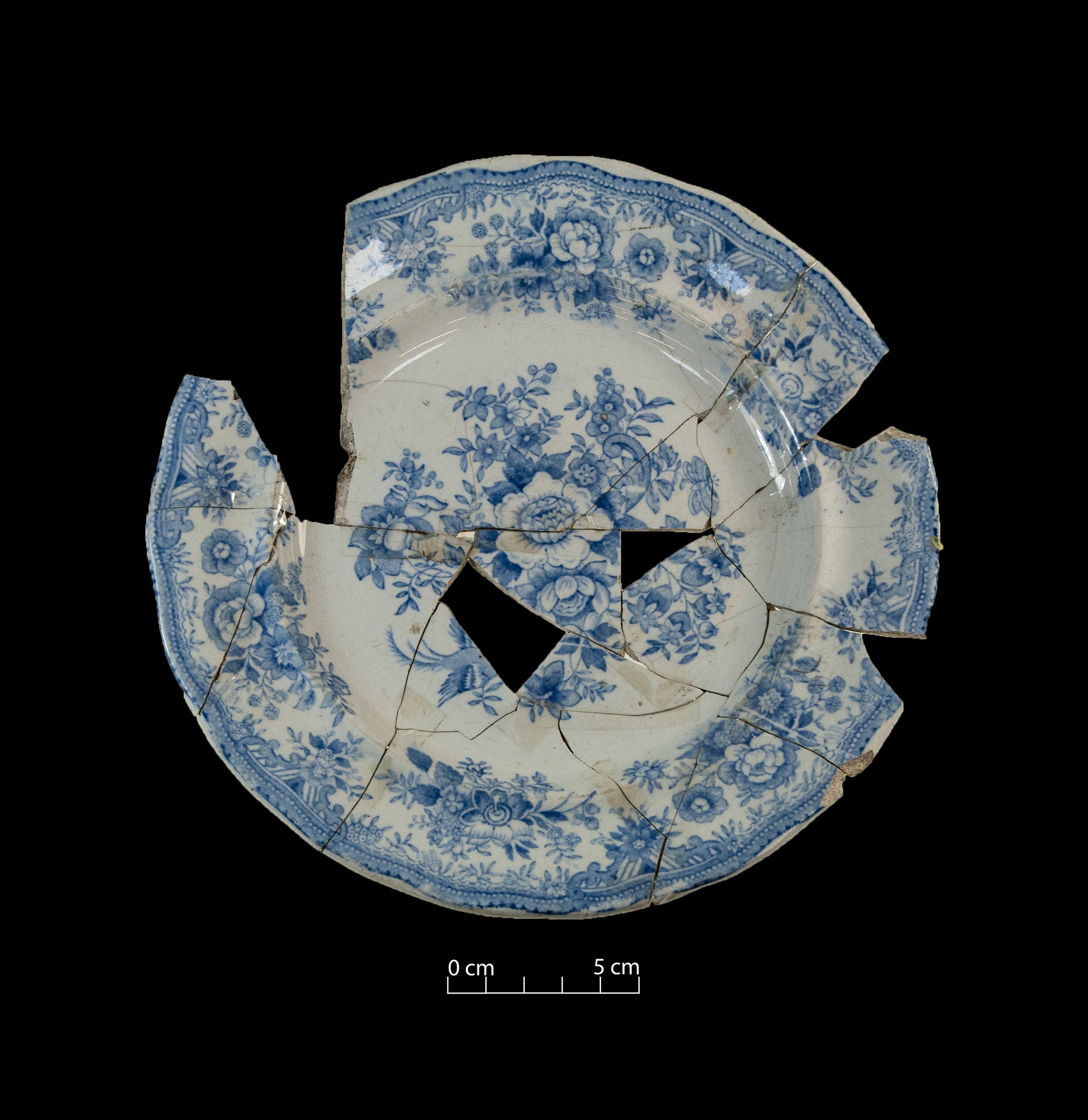 White earthenware plate, decorated with the Asiatic Pheasants pattern (blue). Broken, incomplete.