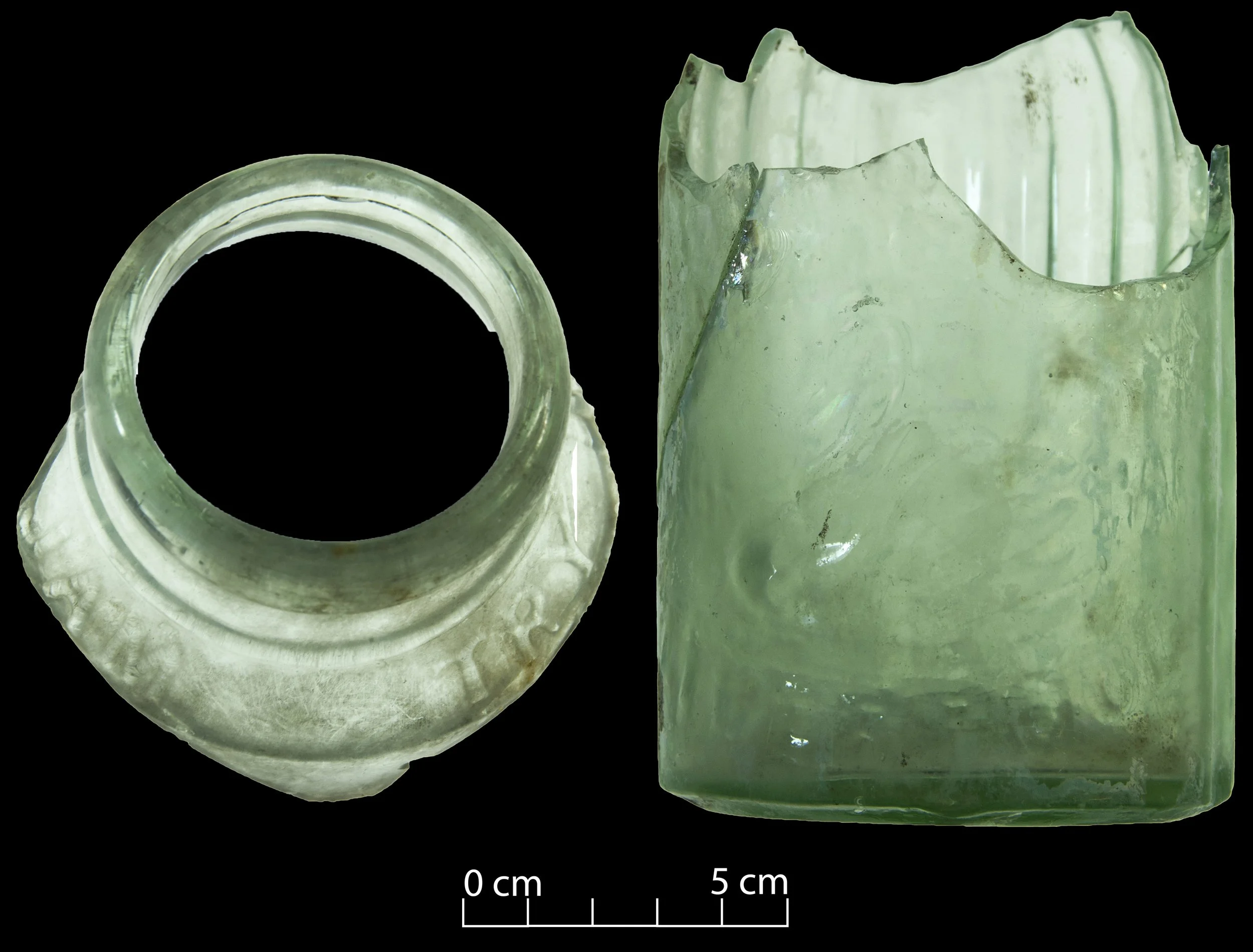 Two light green glass wide mouth pickle jars (the top of one; base & body of a second). Some lettering/embossing visible, including a swan.