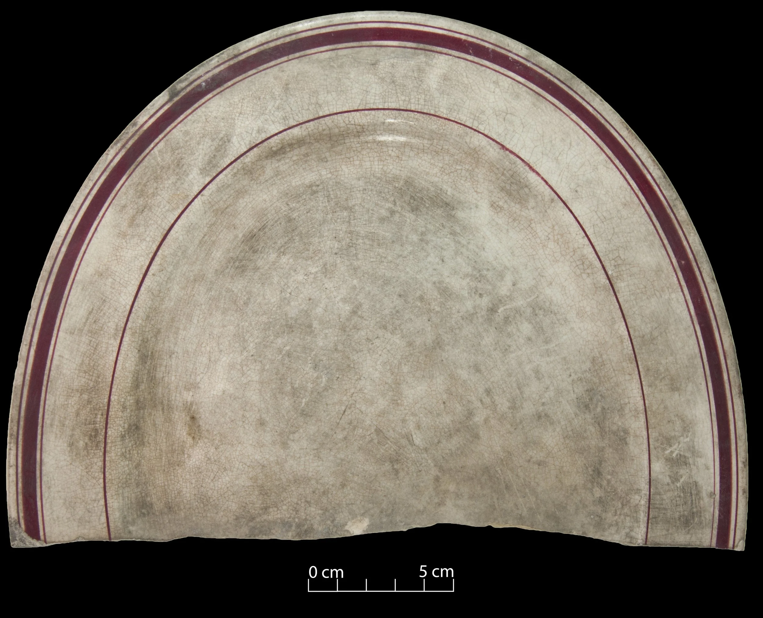 White platter decorated with red bands.