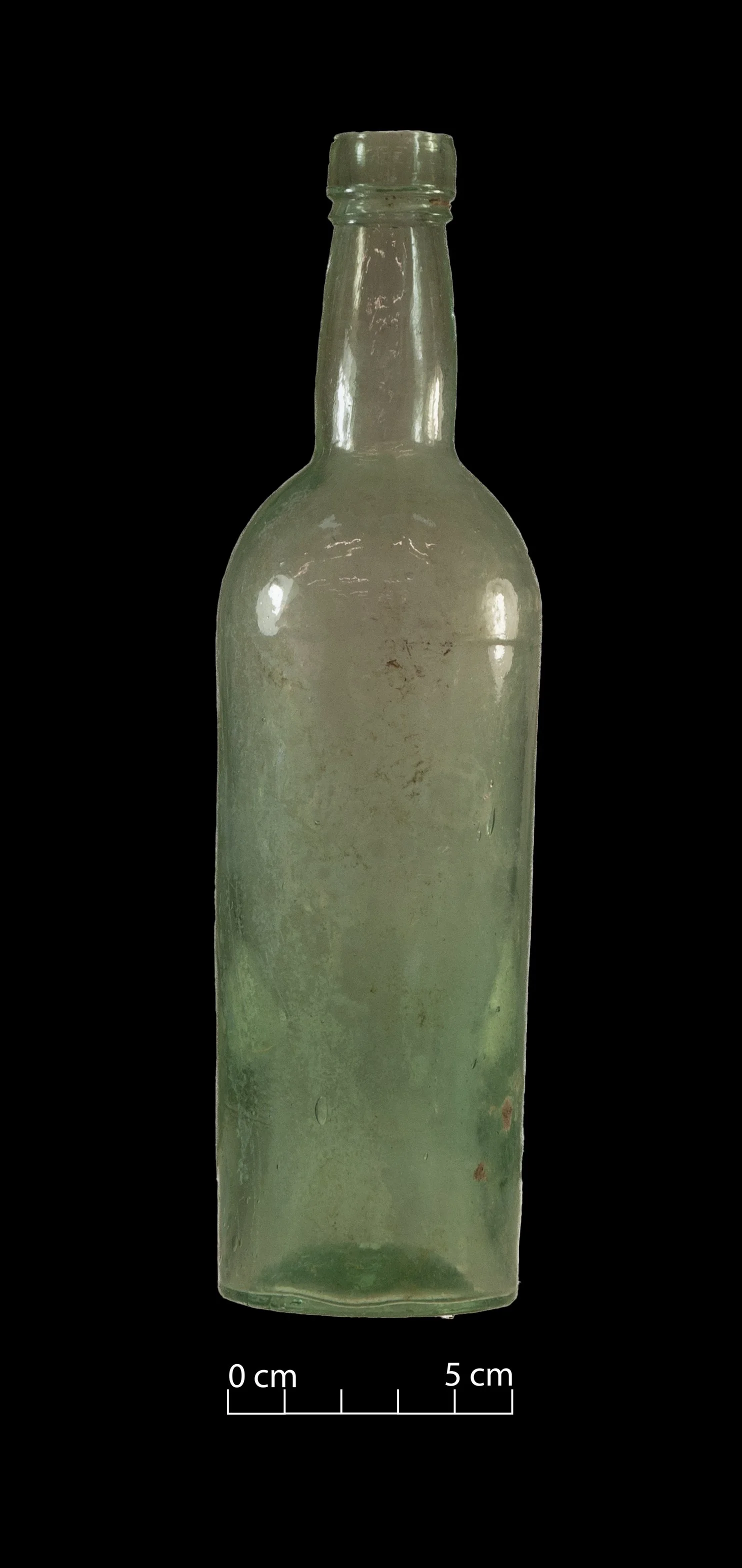 Pale green spirit bottle. Complete.