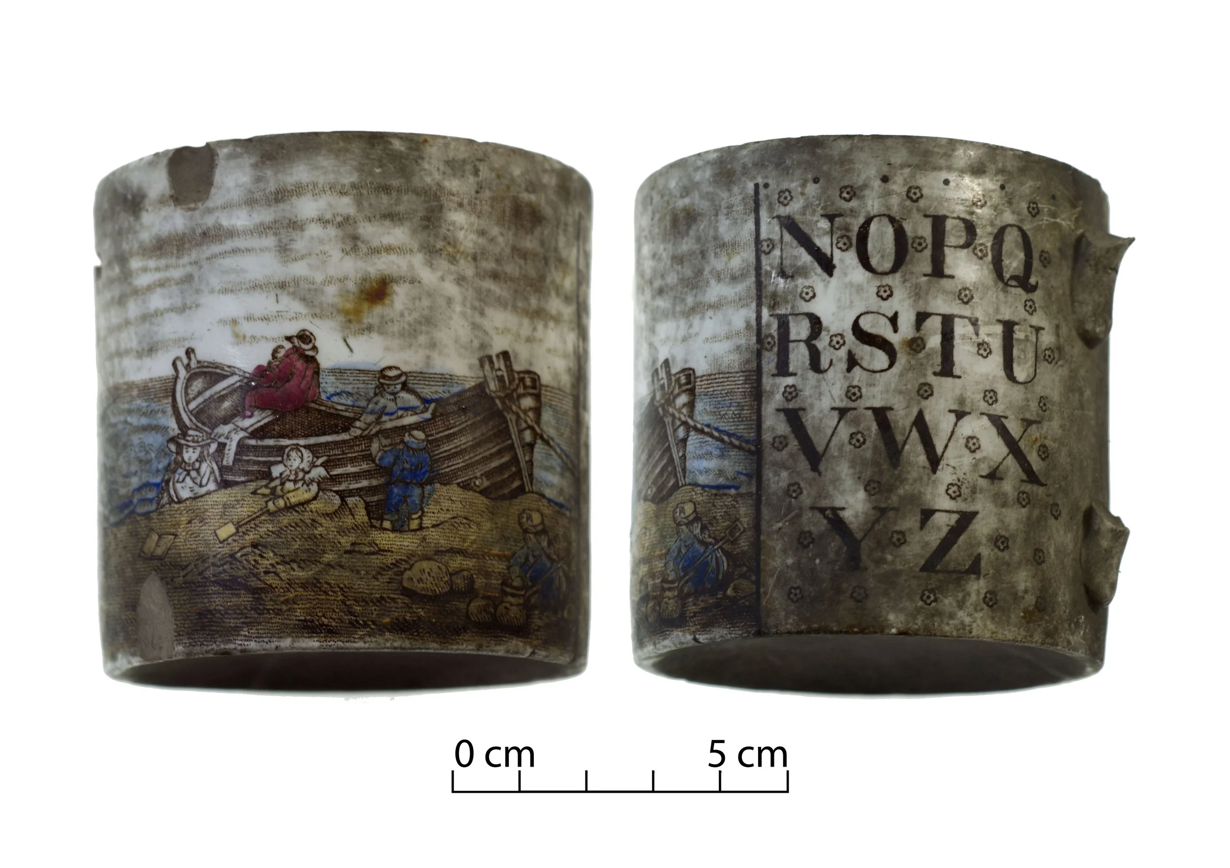 A child's alphabet cup. Letters of the alphabet in brown on one side. Scene with a wooden row boat on the shore, with a family, including young children.