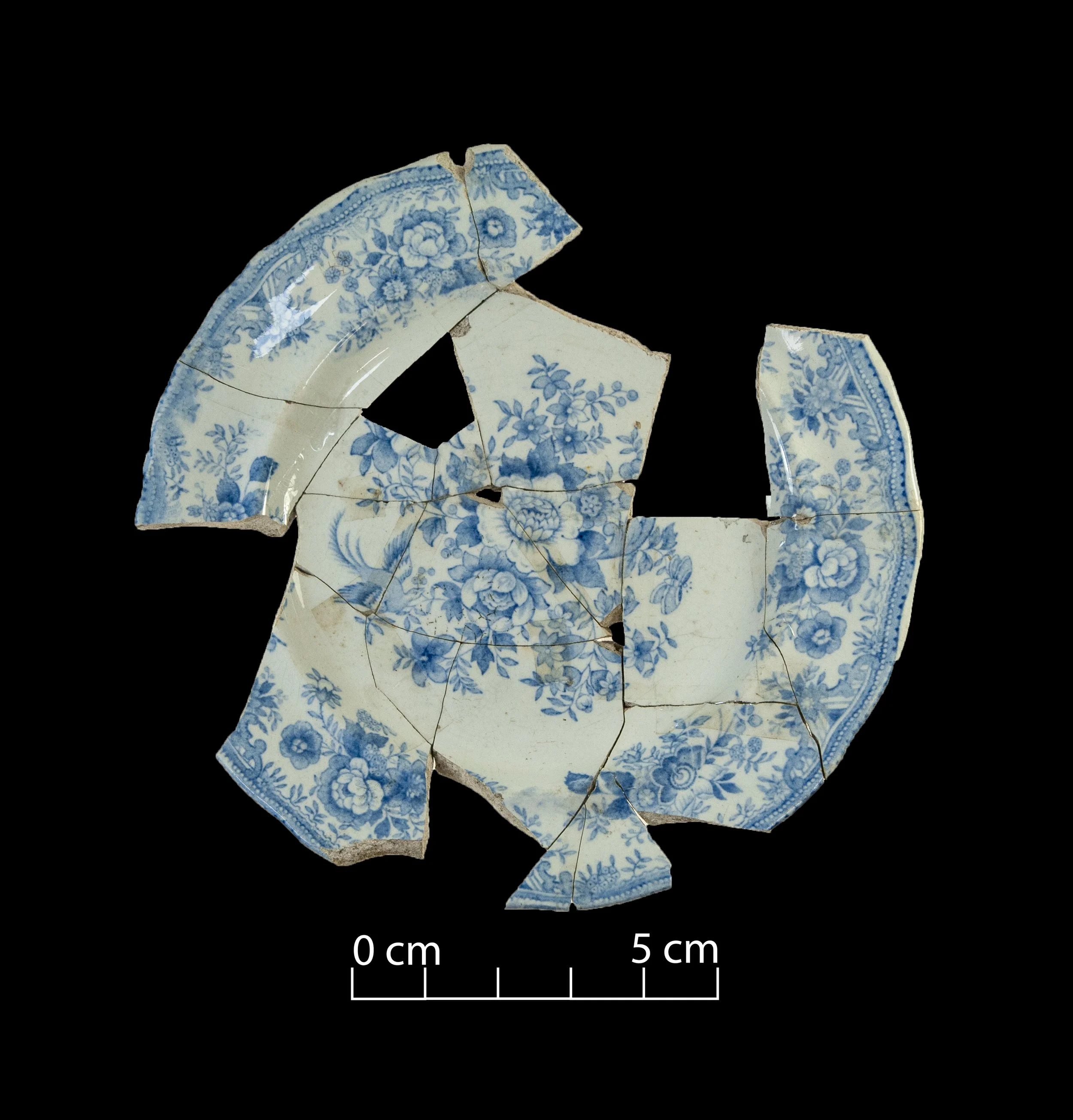 White earthenware plate, decorated with the Asiatic Pheasants pattern (blue). Broken, incomplete.