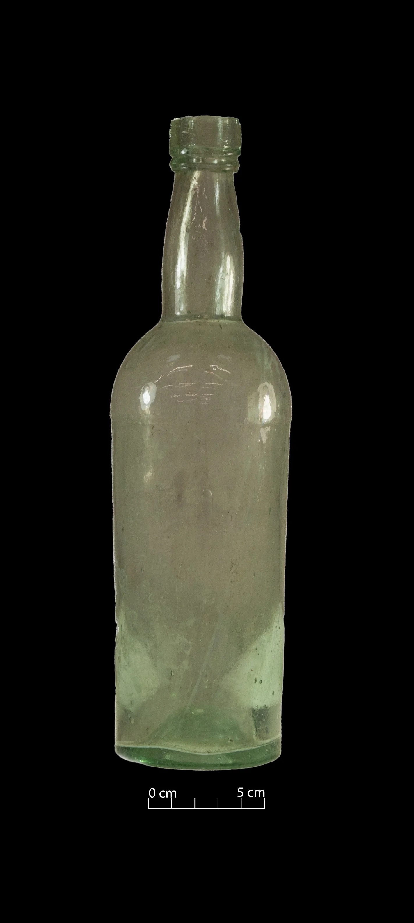 Pale green spirit bottle. Complete.