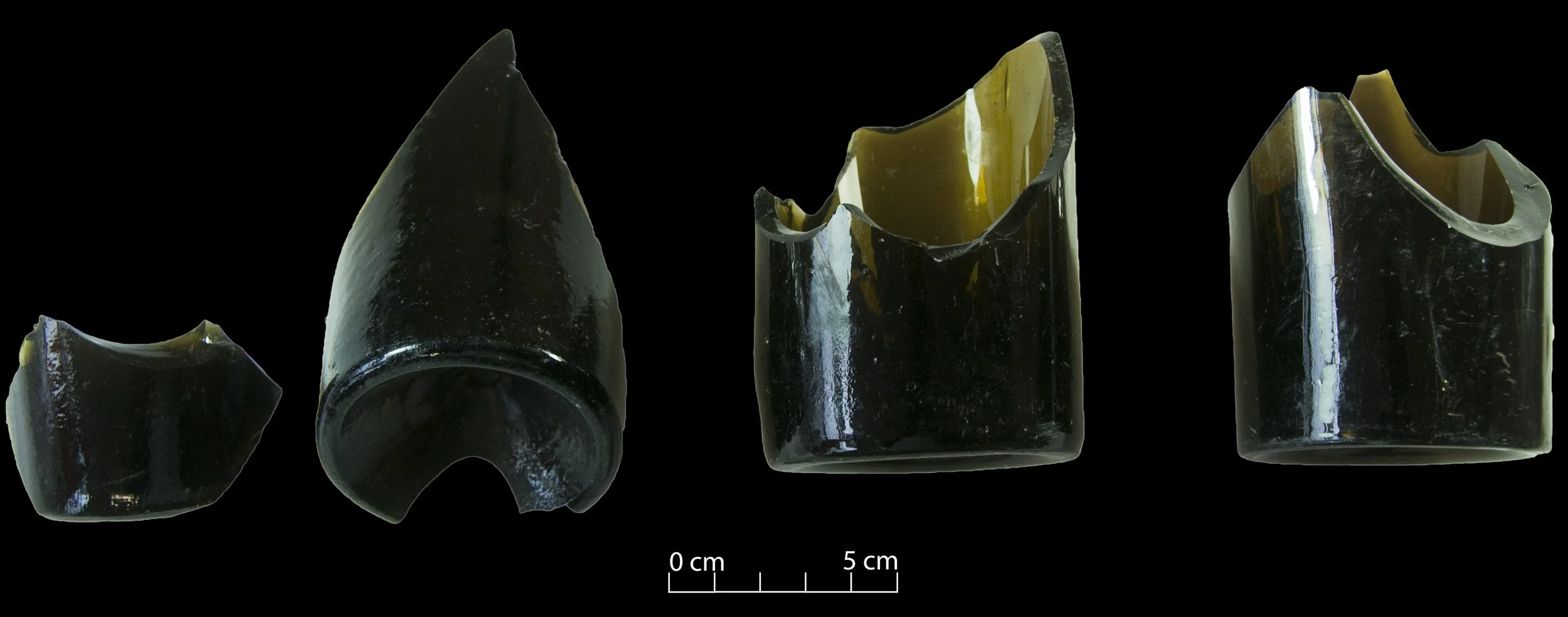 Four black beer bottle bases.