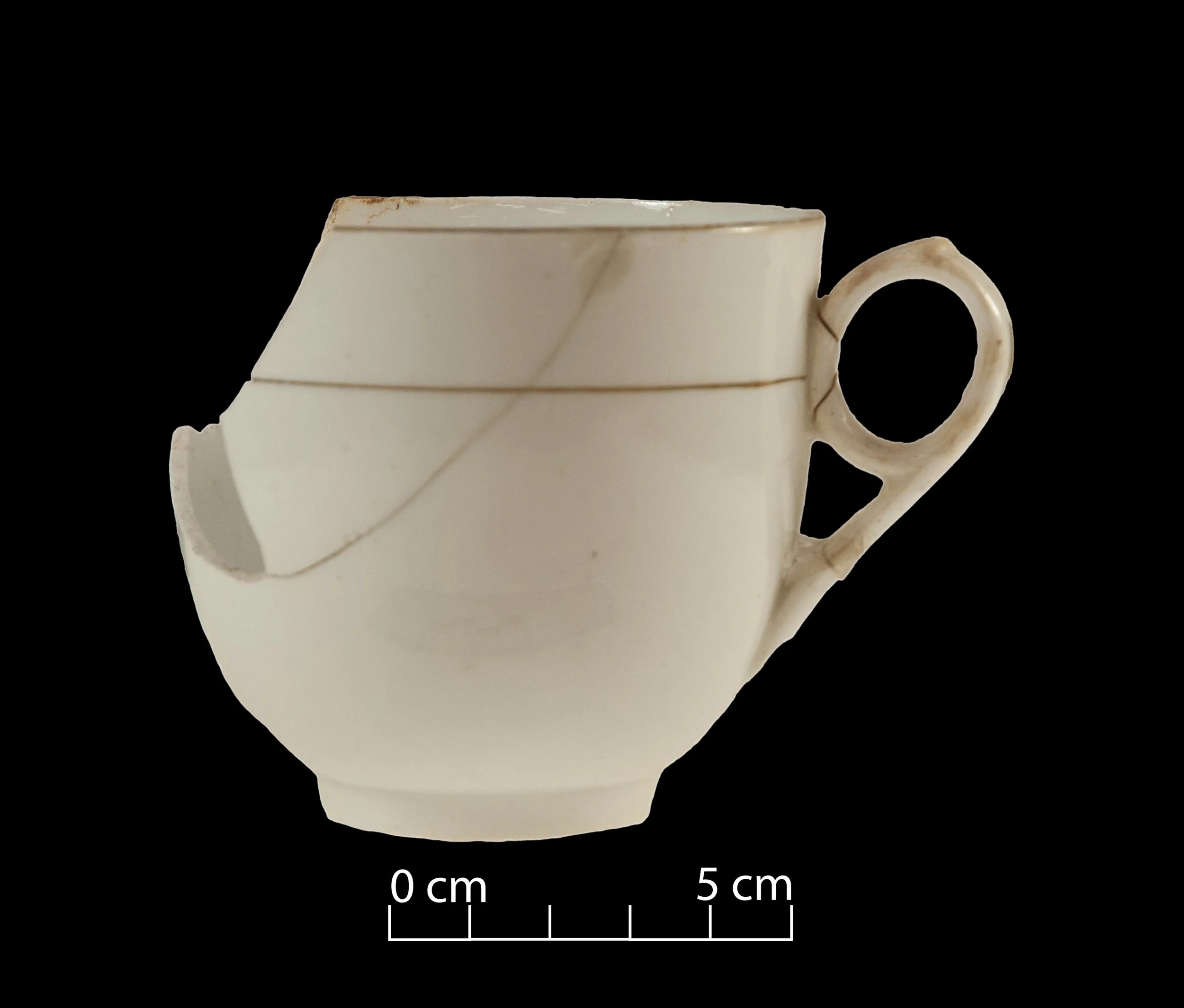 Porcelain tea cup decorated with two gilt lines. Broken, incomplete.