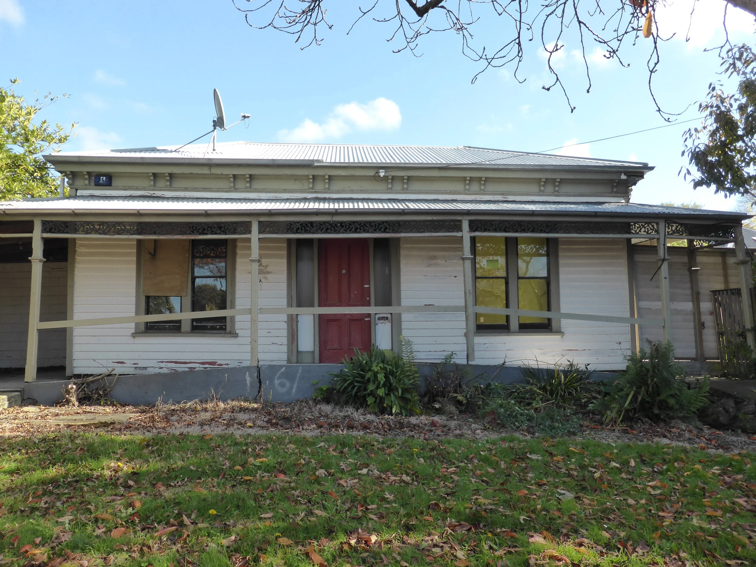 The front/street-facing elevation of a single-storey weatherboard house, with veranda, central front door and pairs of sash windows.