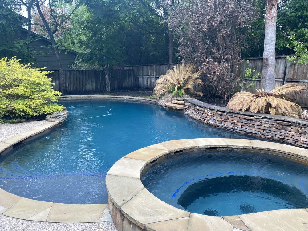 Pool and raised spa with stone wall