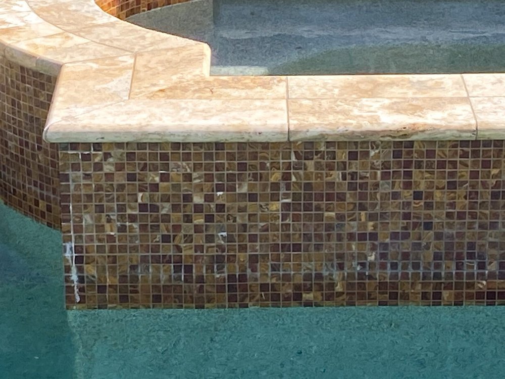Glass mosaic waterline tile on a spa wall after cleaning