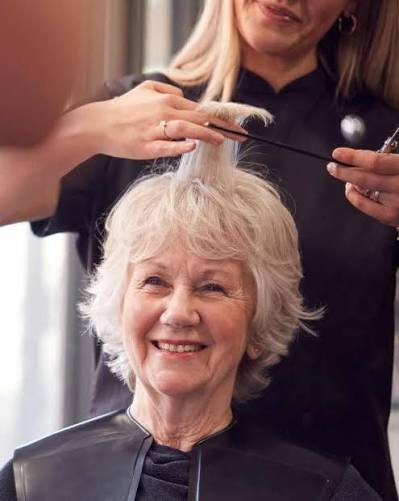 Elderly lady getting a hair cut