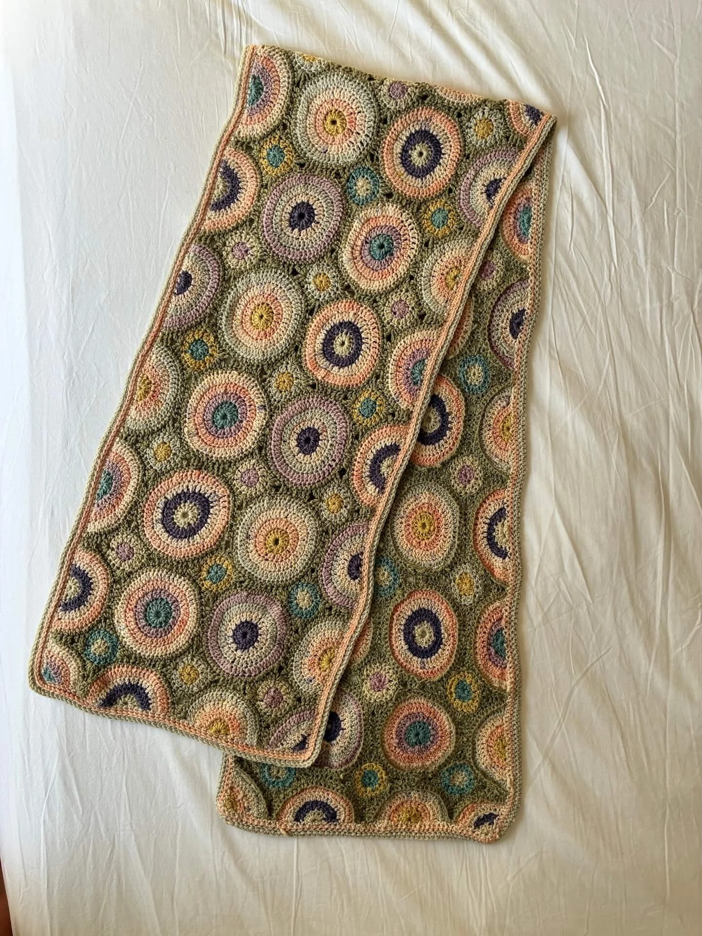 Hand made crochet scarf. The yarn has been naturally dyed in earthy tones and the scarf has been crocheted by hand.