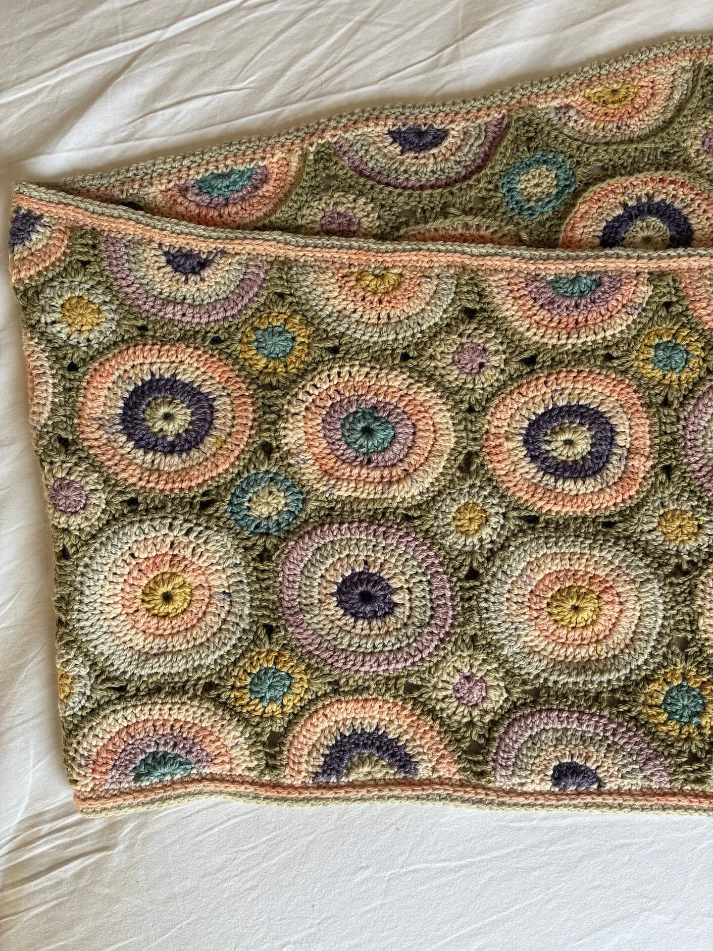 Green and pink and purple wool crocheted shawl