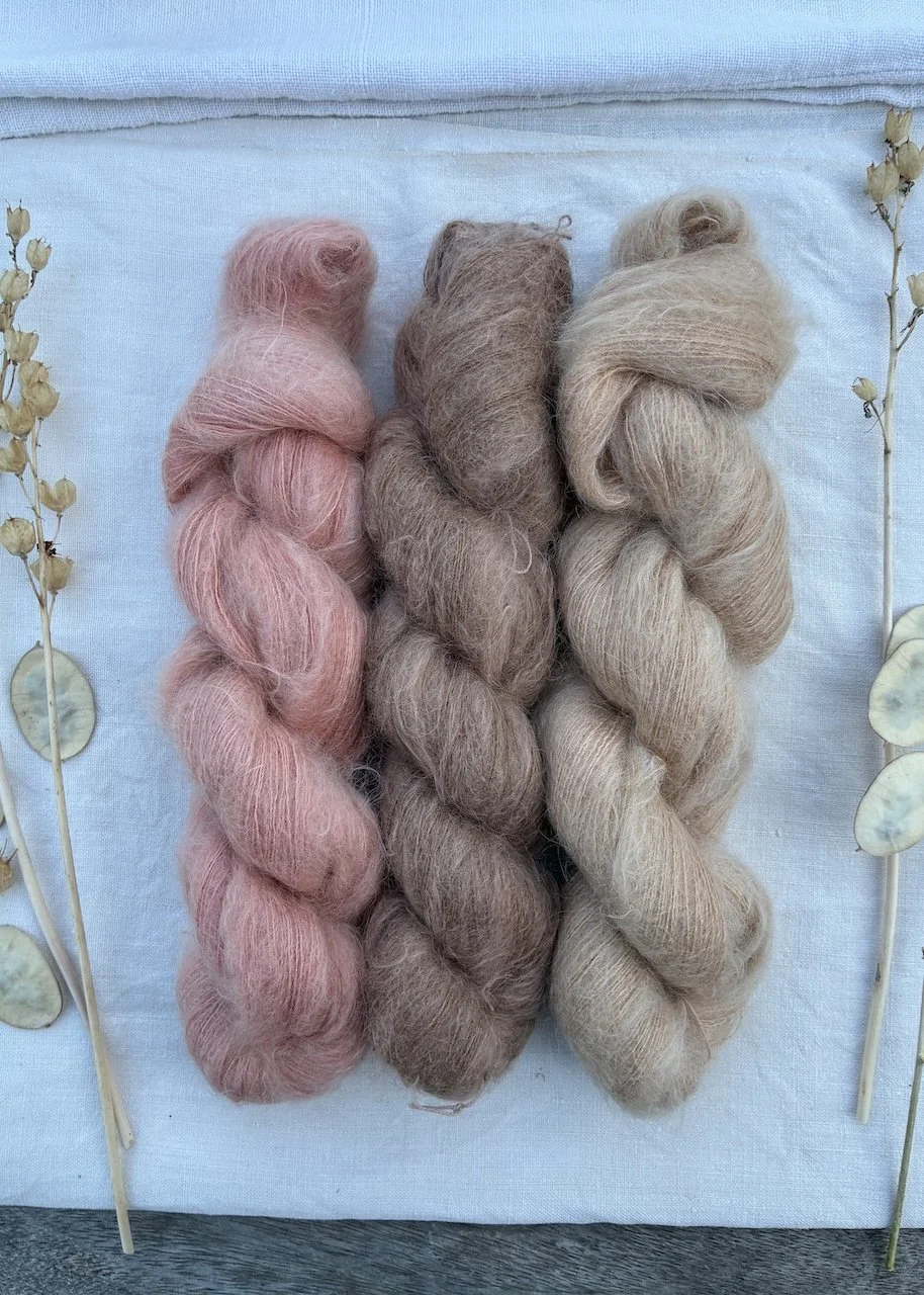 Three skeins of fluffy silk mohair dyed in a range of earthy tones.
